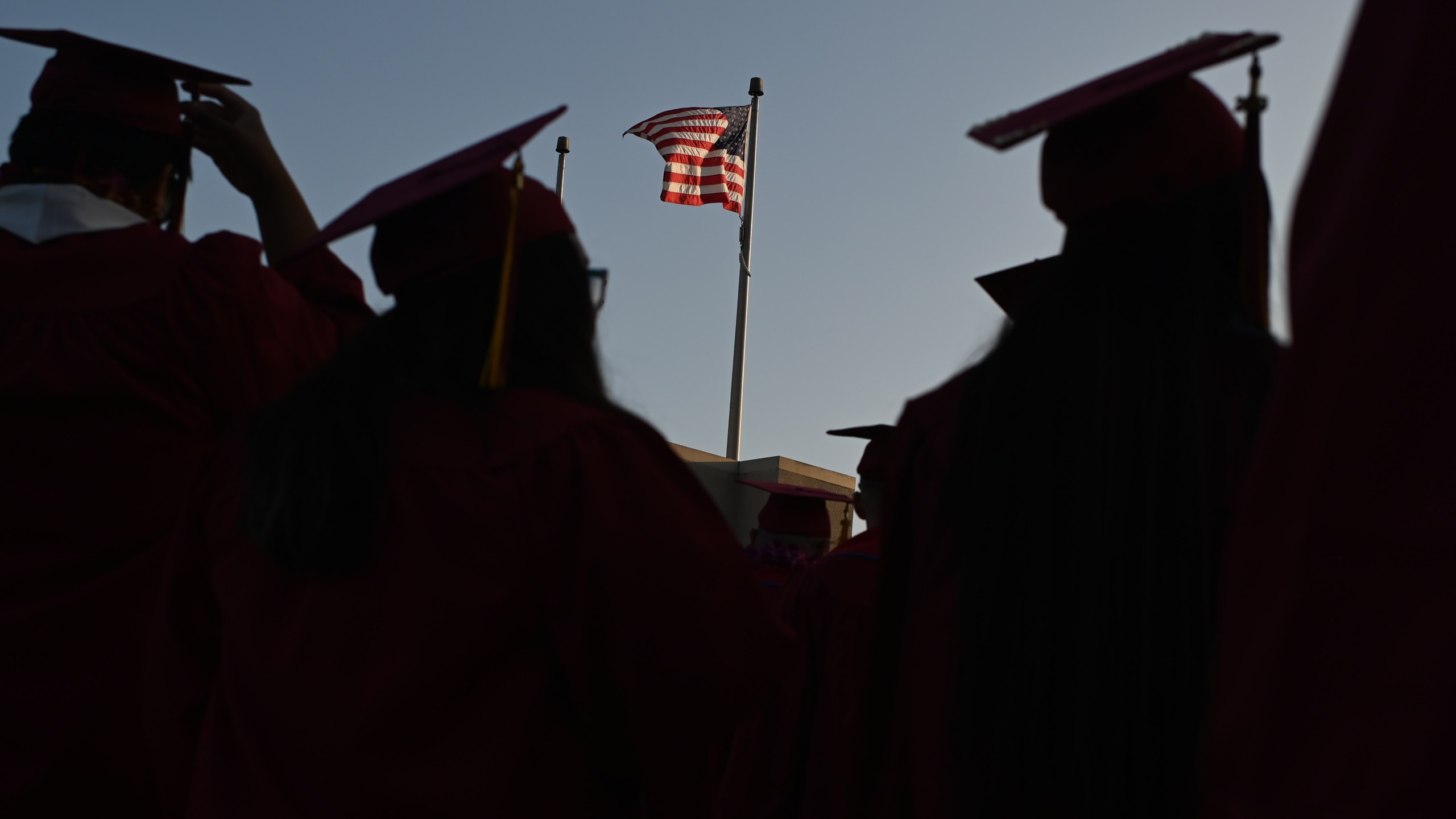 A U.S. flag flies above a building at a Pasadena City College graduation ceremony on June 14, 2019, in Pasadena. (ROBYN BECK/AFP via Getty Images)