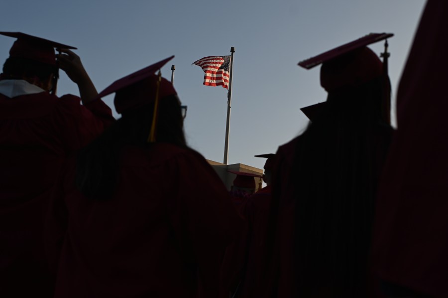 A U.S. flag flies above a building at a Pasadena City College graduation ceremony on June 14, 2019, in Pasadena. (ROBYN BECK/AFP via Getty Images)