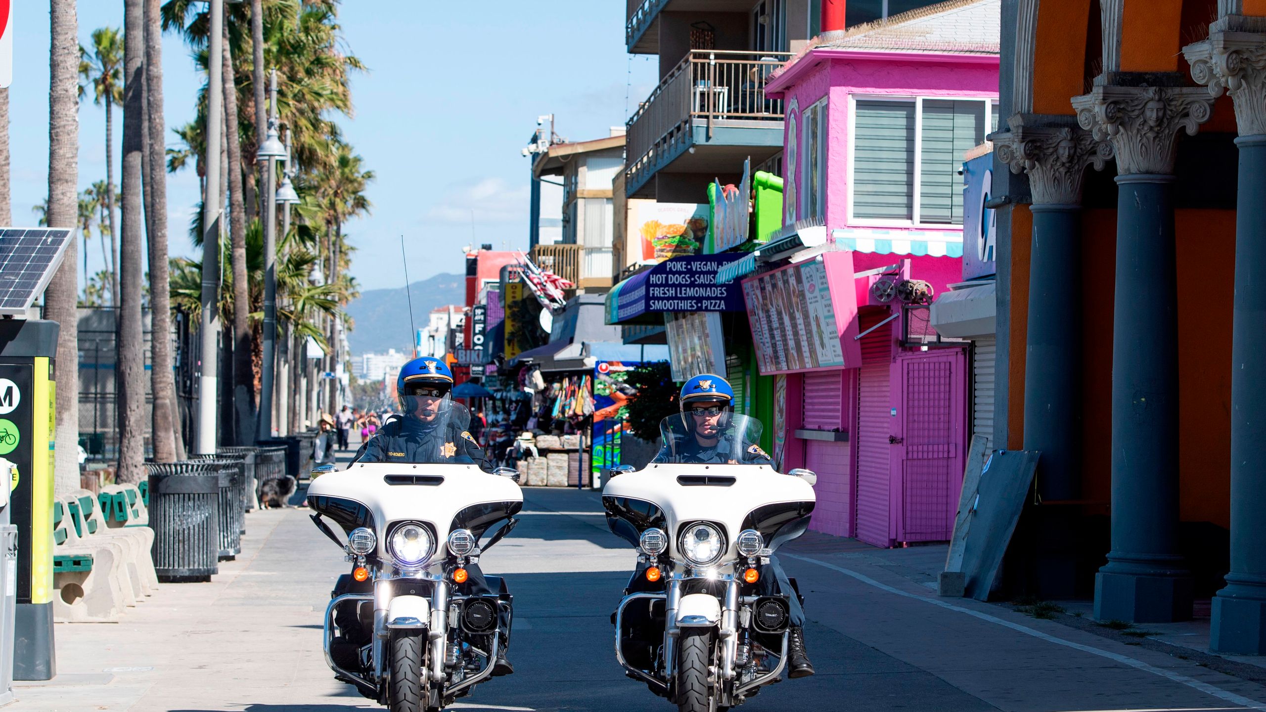 This file photo shows police officers patrolling the boardwalk in Venice Beach on May 13, 2020.(VALERIE MACON/AFP via Getty Images)