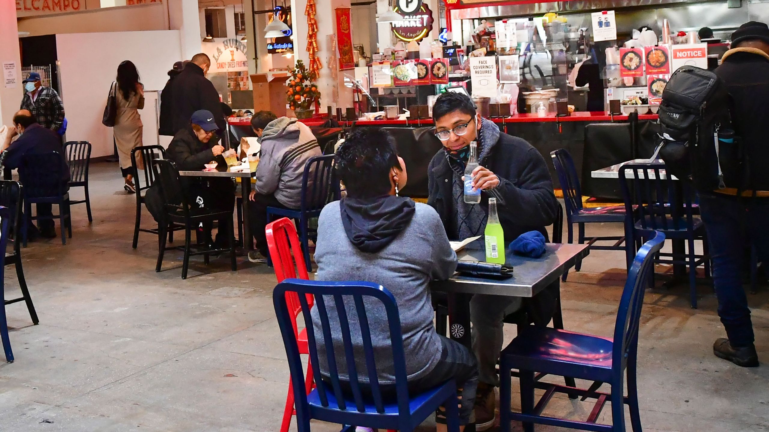 People enjoy lunch at Grand Central Market as indoor dining reopens in Los Angeles, on March 15, 2021. (FREDERIC J. BROWN/AFP via Getty Images)