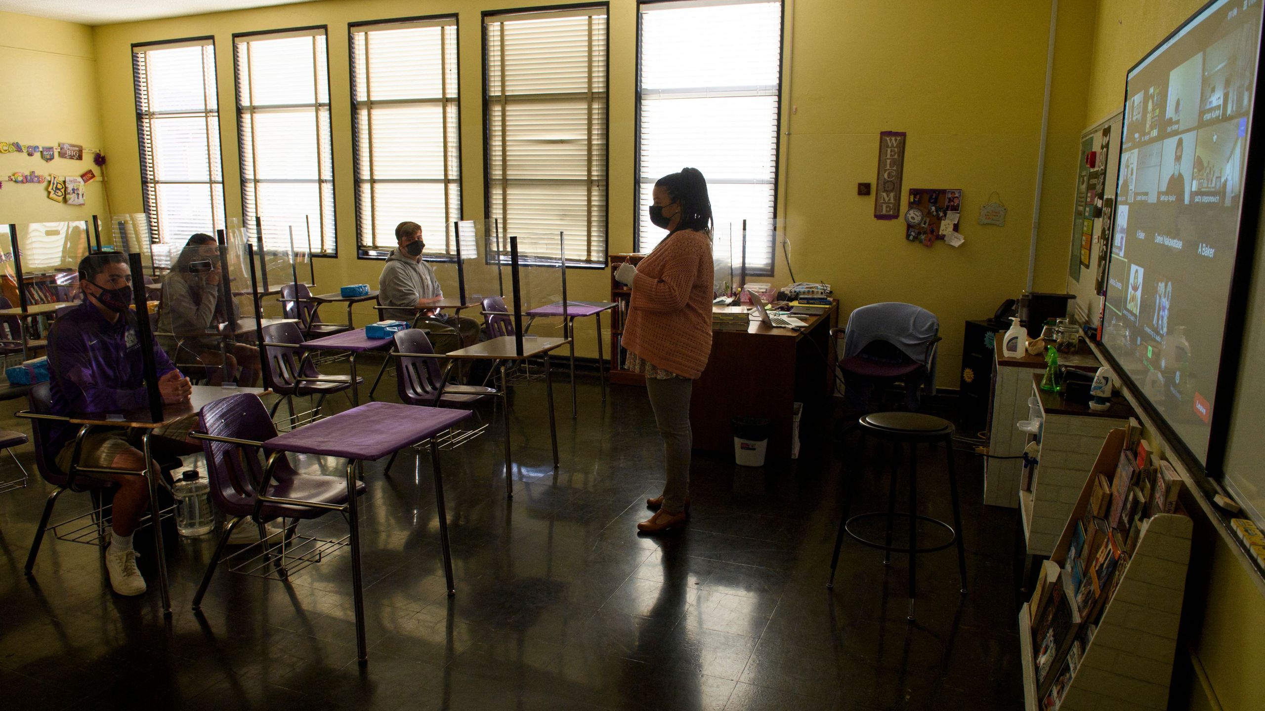 This undated file photo shows a teacher speaking with students in the classroom at a catholic high school in Long Beach on March 24, 2021. (PATRICK T. FALLON/AFP via Getty Images)