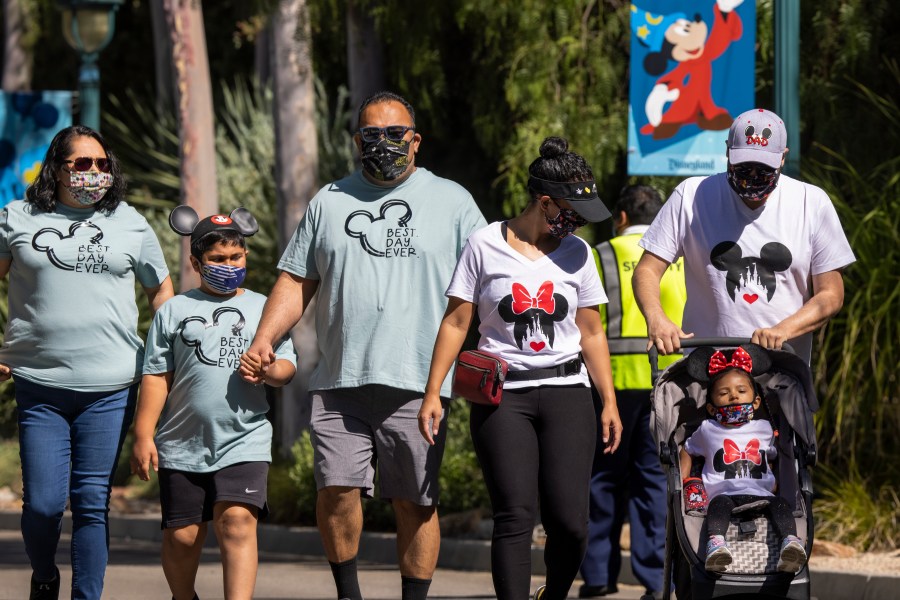 People enter Disneyland Park as it reopens on April 30, 2021, for the first time since the COVID-19 pandemic forced the park to shut down. (David McNew / Getty Images)