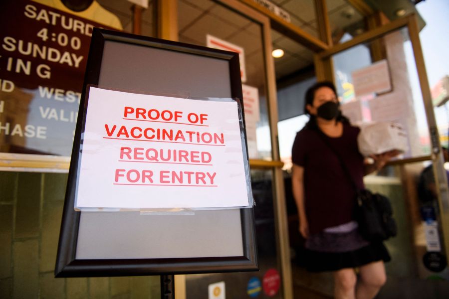 A sign saying that proof of COVID-19 vaccination is required is displayed outside of Langer's Deli in Los Angeles on Aug. 7, 2021. (PATRICK T. FALLON/AFP via Getty Images)