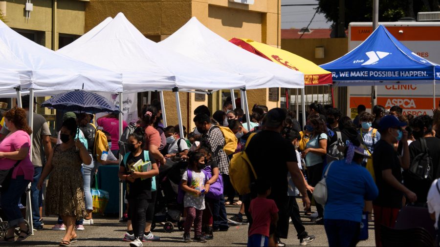 Families attend a back to school event offering school supplies, COVID-19 vaccinations, face masks and other resources for children and their families at the Weingart East Los Angeles YMCA on Aug. 7, 2021. (Patrick T. Fallon / AFP / Getty Images)