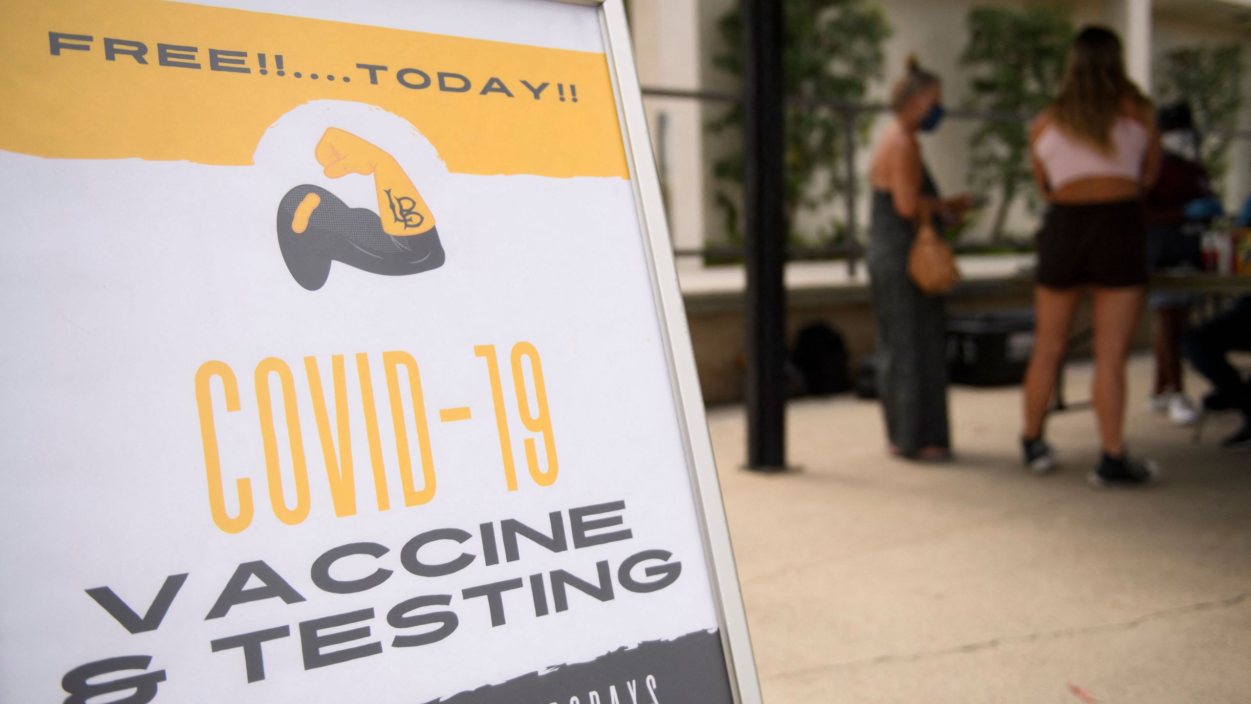 Free COVID-19 vaccine and testing signage is displayed during a City of Long Beach Public Health Covid-19 mobile vaccination clinic at the California State University Long Beach campus on Aug. 11, 2021 in Long Beach. (PATRICK T. FALLON/AFP via Getty Images)