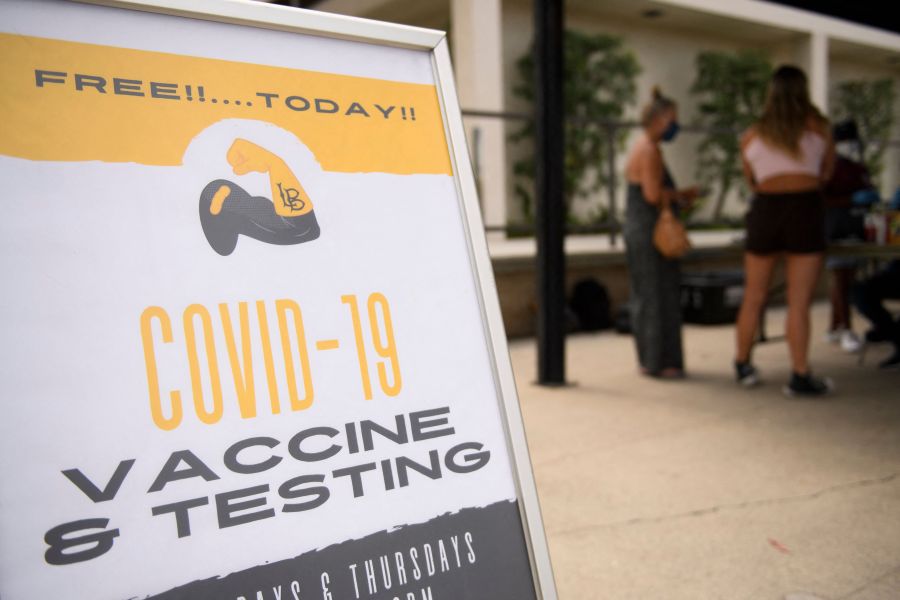 Free COVID-19 vaccine and testing signage is displayed during a City of Long Beach Public Health Covid-19 mobile vaccination clinic at the California State University Long Beach campus on Aug. 11, 2021 in Long Beach. (PATRICK T. FALLON/AFP via Getty Images)