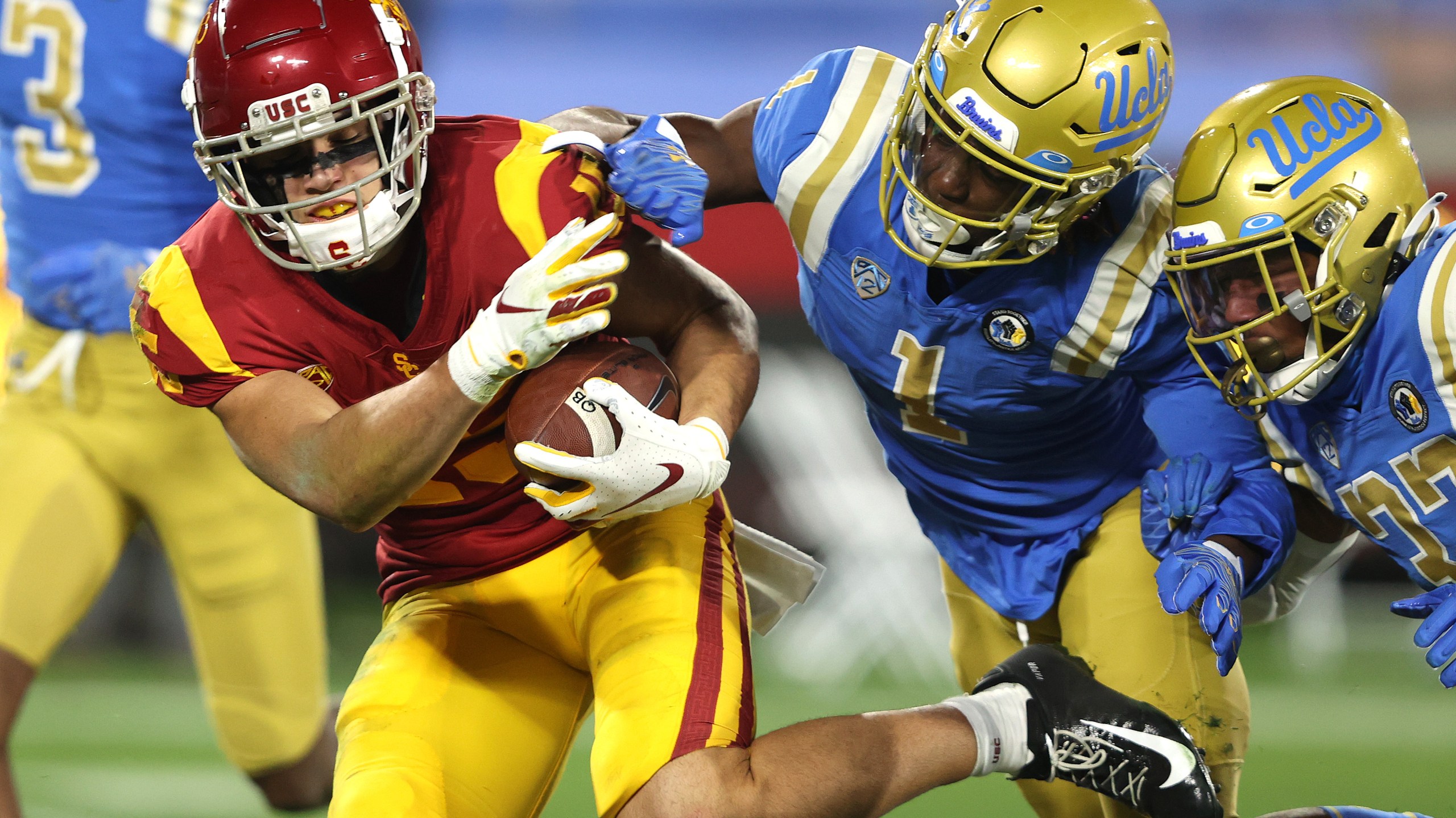 Drake London #15 of the USC Trojans runs past Jay Shaw #1 and Quentin Lake #37 of the UCLA Bruins for a touchdown during the first half of a game at the Rose Bowl on December 12, 2020 in Pasadena. (Sean M. Haffey/Getty Images)