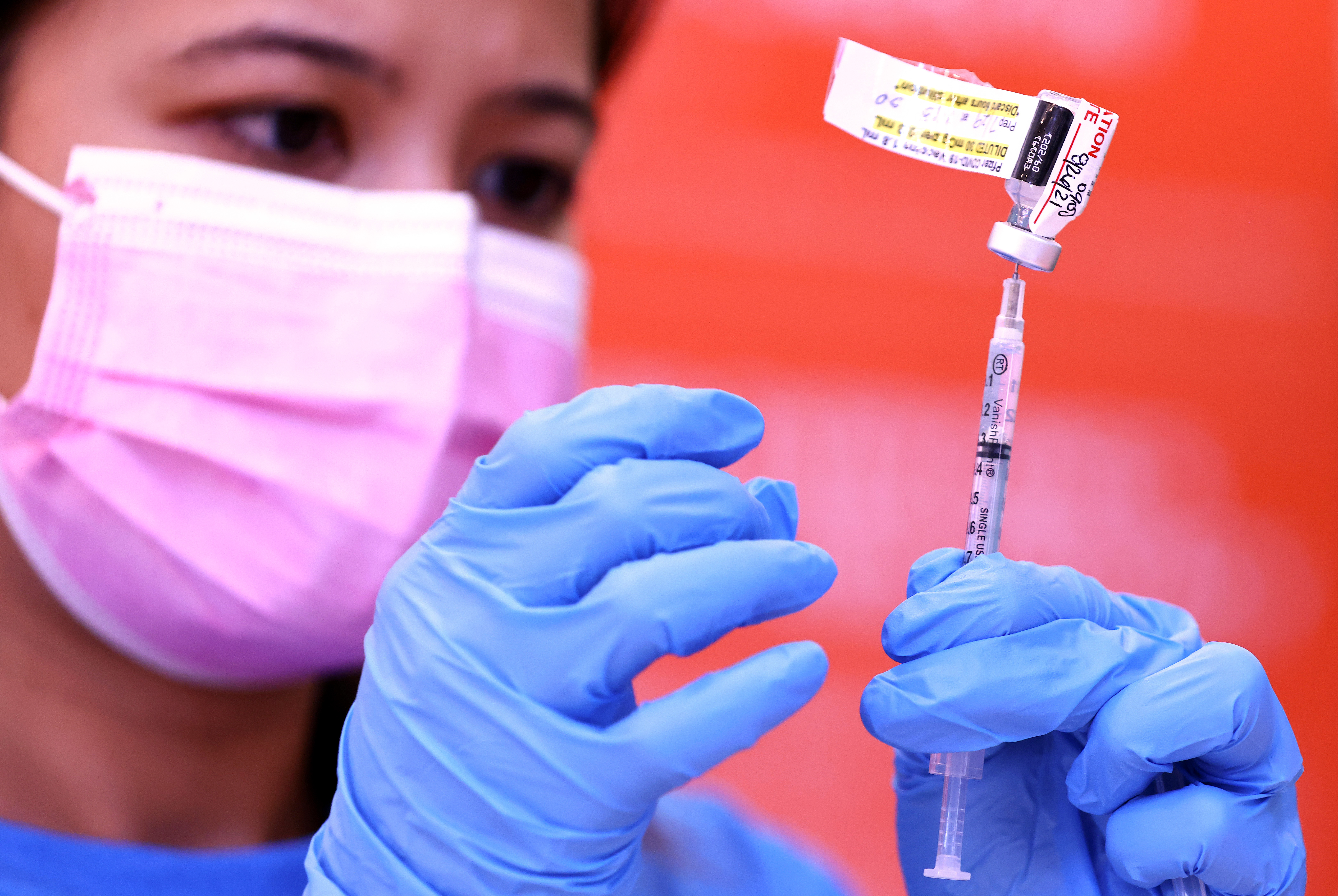 Registered nurse Darryl Hana prepares a dose of the Pfizer COVID-19 vaccine at a three-day vaccination clinic at Providence Wilmington Wellness and Activity Center on July 29, 2021, in Wilmington, California. (Mario Tama/Getty Images)