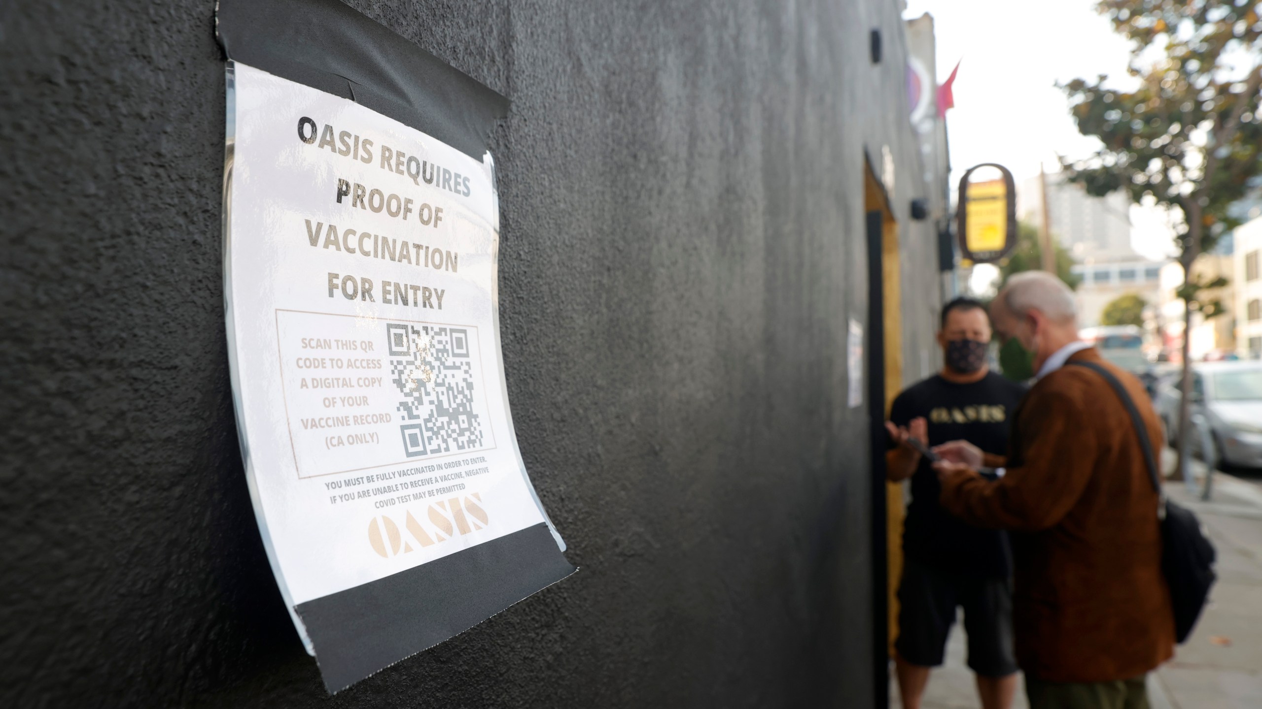 A sign is posted on the front of Oasis announcing that proof of vaccination is required for entry into the club on July 29, 2021 in San Francisco. (Justin Sullivan/Getty Images)