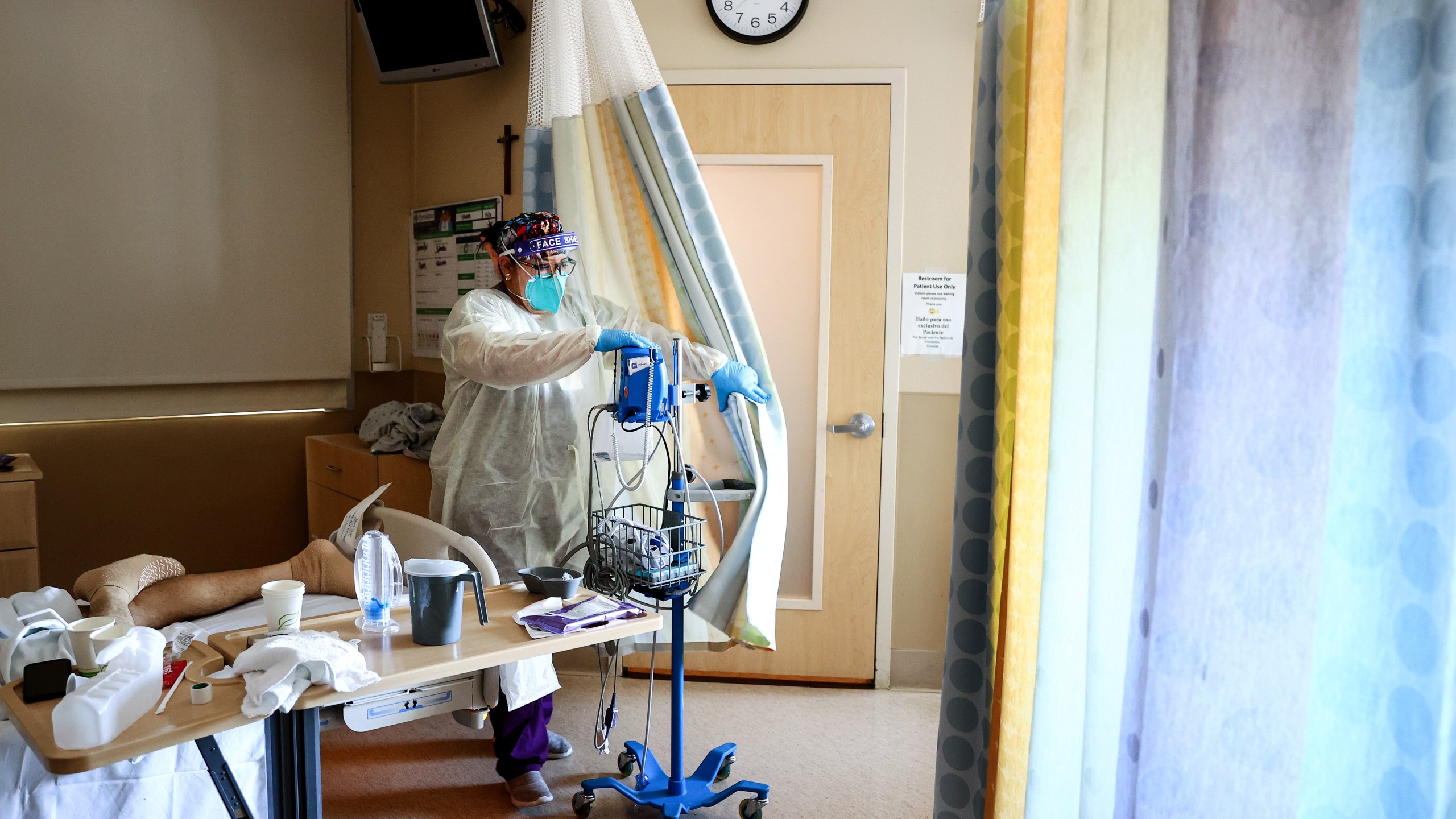 Certified Nursing Assistant Paulette Santillan departs after checking a COVID-19 patient's vital signs in the improvised COVID-19 unit at Providence Holy Cross Medical Center in the Mission Hills neighborhood on July 30, 2021, in Los Angeles, California. (Mario Tama/Getty Images)