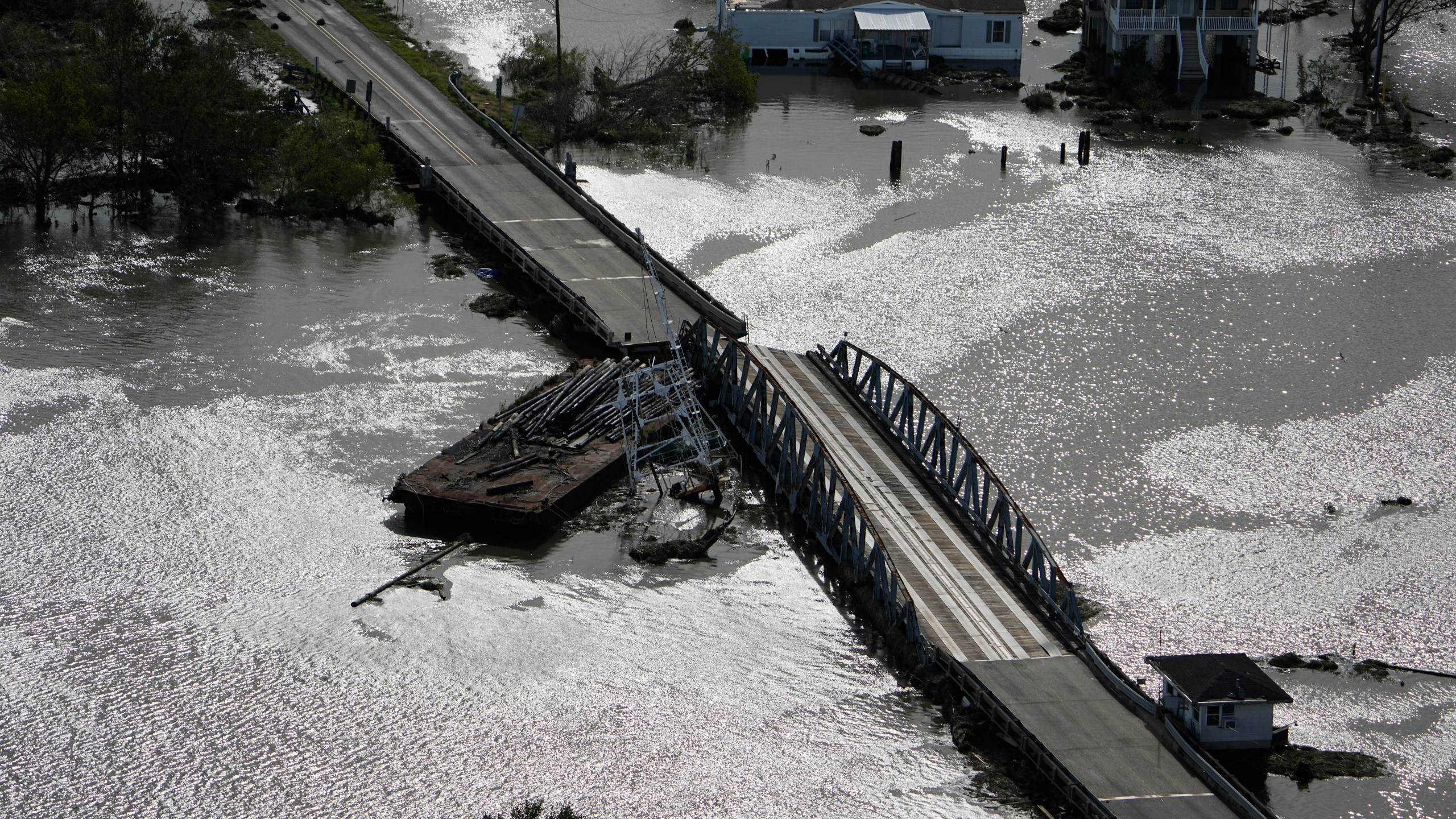 A barge damages a bridge that divides Lafitte, La., and Jean Lafitte, in the aftermath of Hurricane Ida, Monday, Aug. 30, 2021. (AP Photo/David J. Phillip)