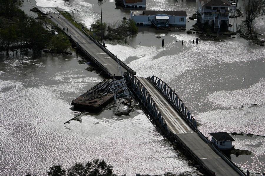 A barge damages a bridge that divides Lafitte, La., and Jean Lafitte, in the aftermath of Hurricane Ida, Monday, Aug. 30, 2021. (AP Photo/David J. Phillip)