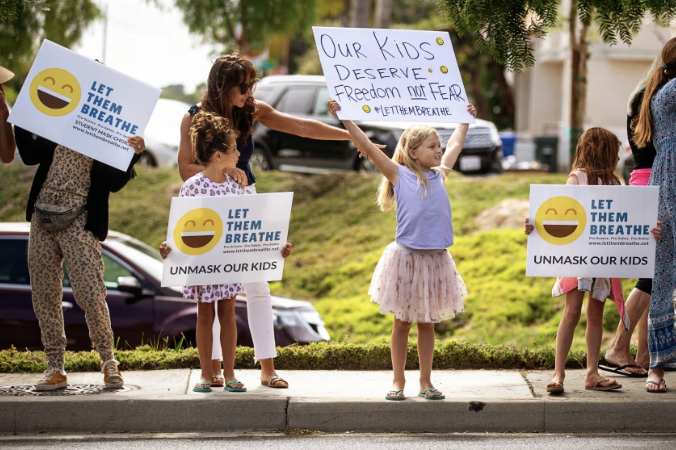 Adults and children with Let Them Breathe, an anti-mask group, protest at the Redondo Beach Unified School District building in July.(Jason Armond / Los Angeles Times)