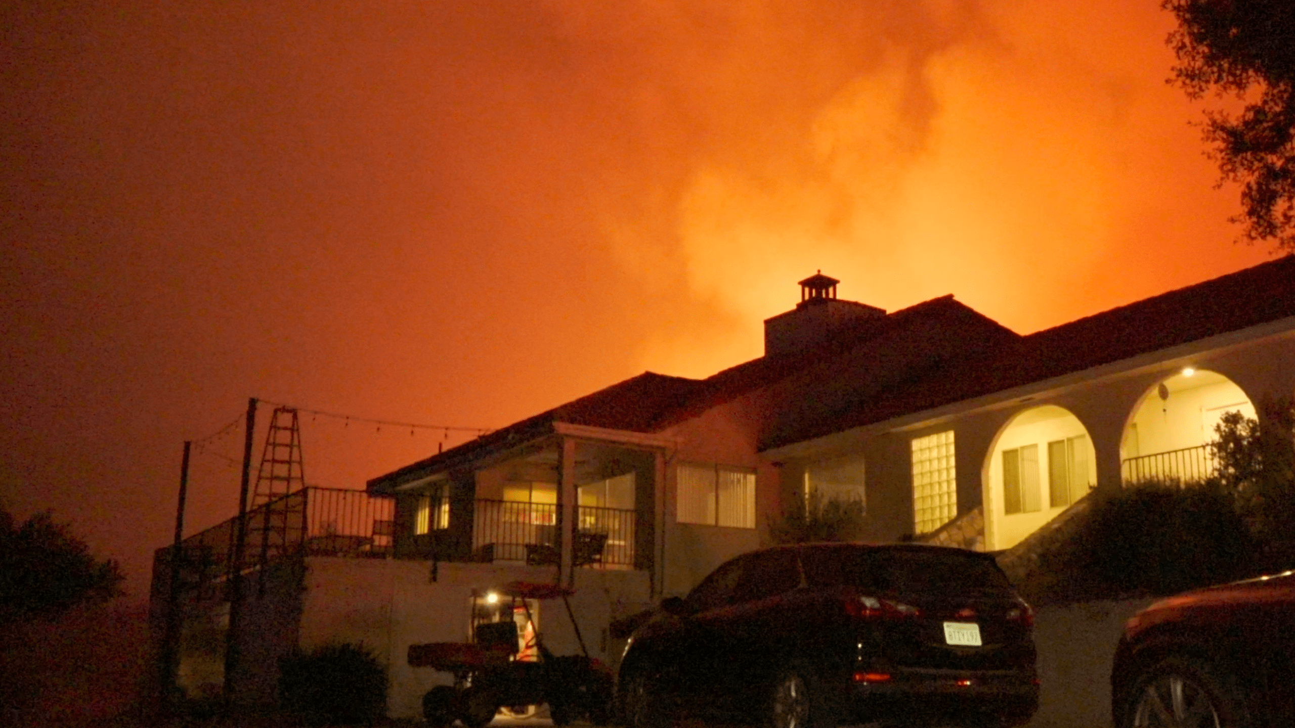 The Chapparal Fire burns behind a home near the community of La Cresta on Aug. 29, 2021. (Onscene.TV)