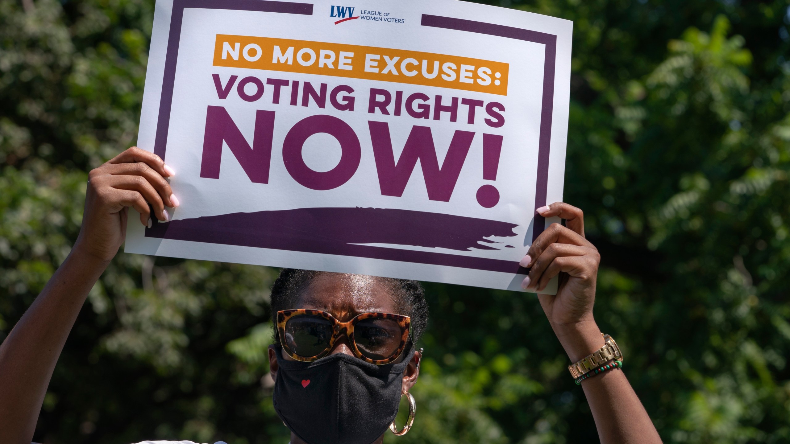 LaQuita Howard of Washington, with the League of Women Voters, attends a rally for voting rights, Tuesday, Aug. 24, 2021, near the White House in Washington. (AP Photo/Jacquelyn Martin)