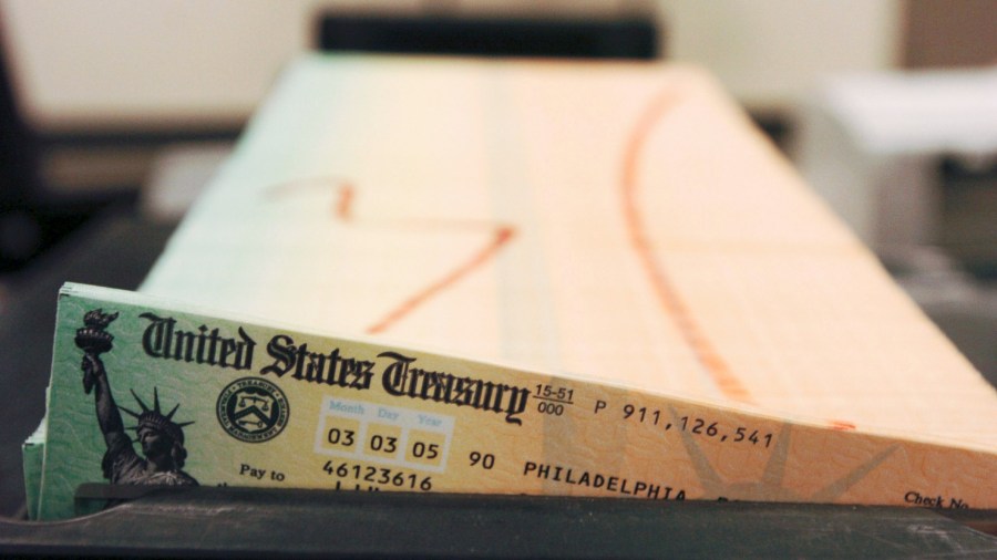 In this Feb. 11, 2005 file photo, trays of printed social security checks wait to be mailed from the U.S. Treasury's Financial Management services facility in Philadelphia. The financial impact of the coronavirus pandemic on Social Security and Medicare is front and center as the government releases its annual report on the state of the bedrock retirement programs on Tuesday, Aug. 31, 2021. (AP Photo/Bradley C. Bower, File)