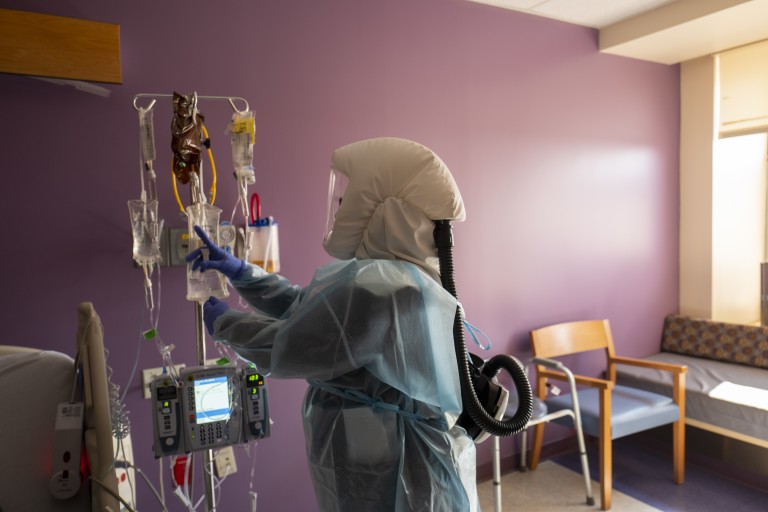 Registered nurse Shawna Gibson prepares an IV and medications for a COVID-19 patient at White Memorial Hospital in Los Angeles on Aug. 13, 2021. (Francine Orr / Los Angeles Times)