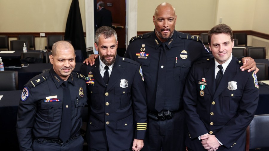 From left, U.S. Capitol Police Sgt. Aquilino Gonell, Washington Metropolitan Police Department officer Michael Fanone, U.S. Capitol Police Sgt. Harry Dunn and Washington Metropolitan Police Department officer Daniel Hodges pose for a photo after a House select committee hearing on the Jan. 6 attack on Capitol Hill in Washington, Tuesday, July 27, 2021. (Oliver Contreras/The New York Times via AP, Pool)