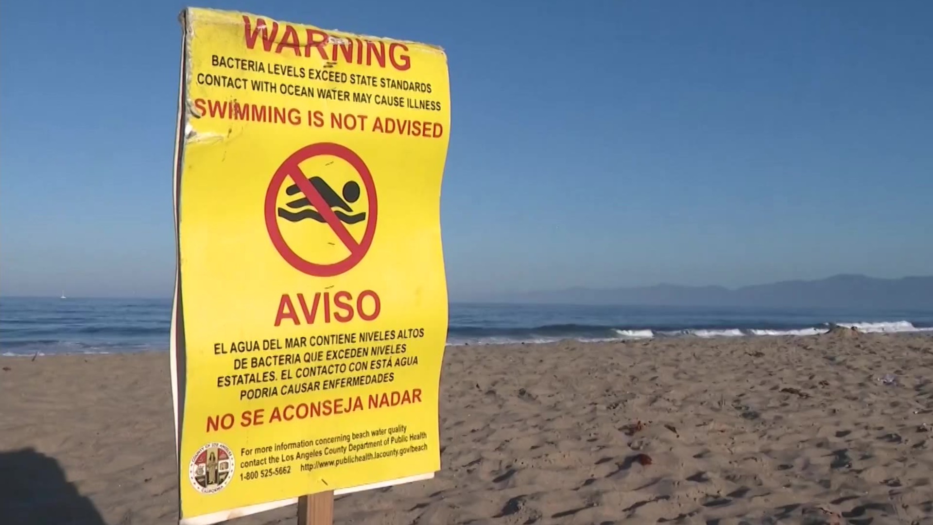 A sign warning swimmers about high bacteria levels is seen on a Southern California beach in this file image. (KTLA)