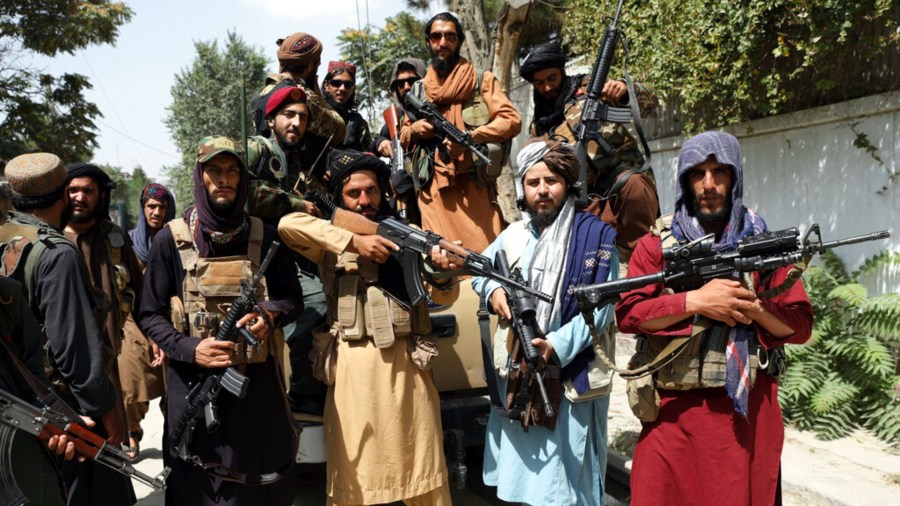 Taliban fighters pose for a photograph in Kabul, Afghanistan, Thursday, Aug. 19, 2021. (AP Photo/Rahmat Gul)