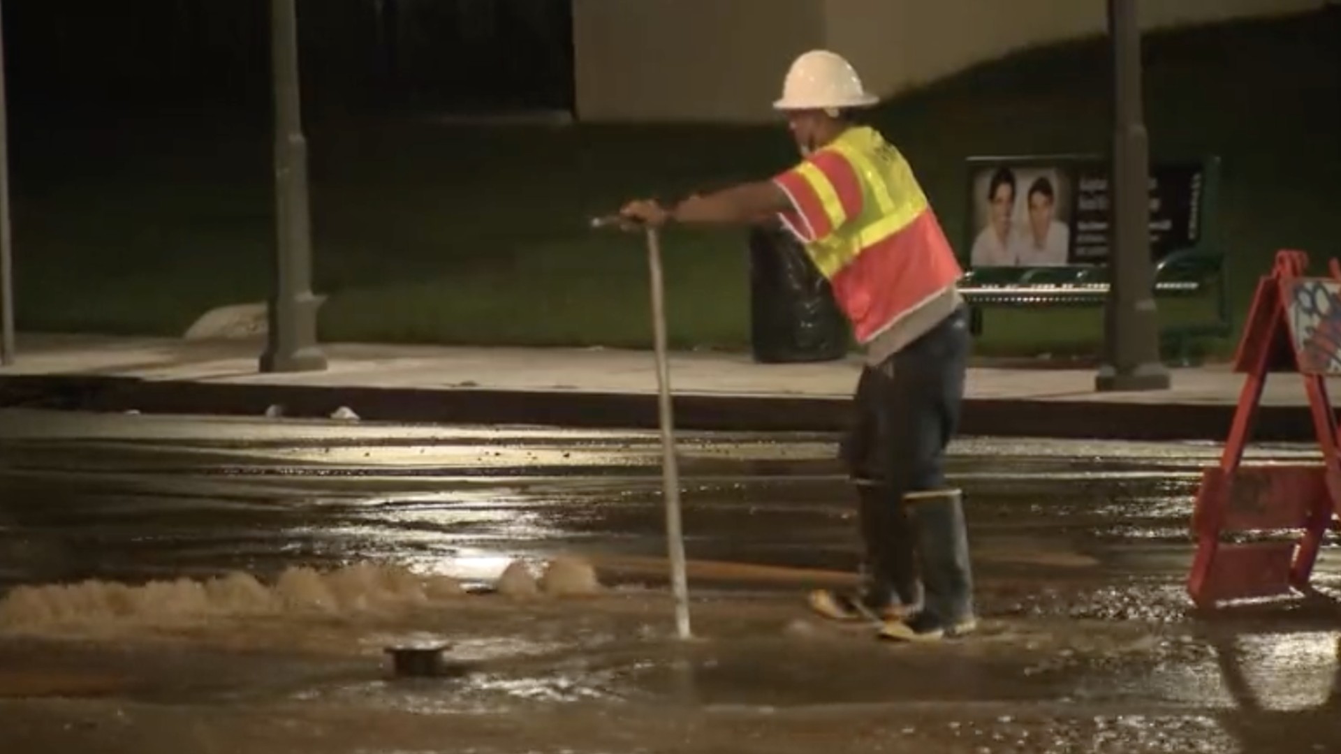 An LADWP worker responds to a water main break in Sherman Oaks on Aug. 25, 2021. (KTLA)