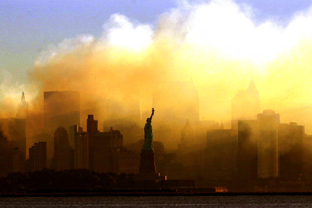 In this Saturday, Sept. 15, 2001 file photo, the Statue of Liberty stands in front of a smoldering lower Manhattan at dawn, seen from Jersey City, N.J. (AP Photo/Dan Loh, File)