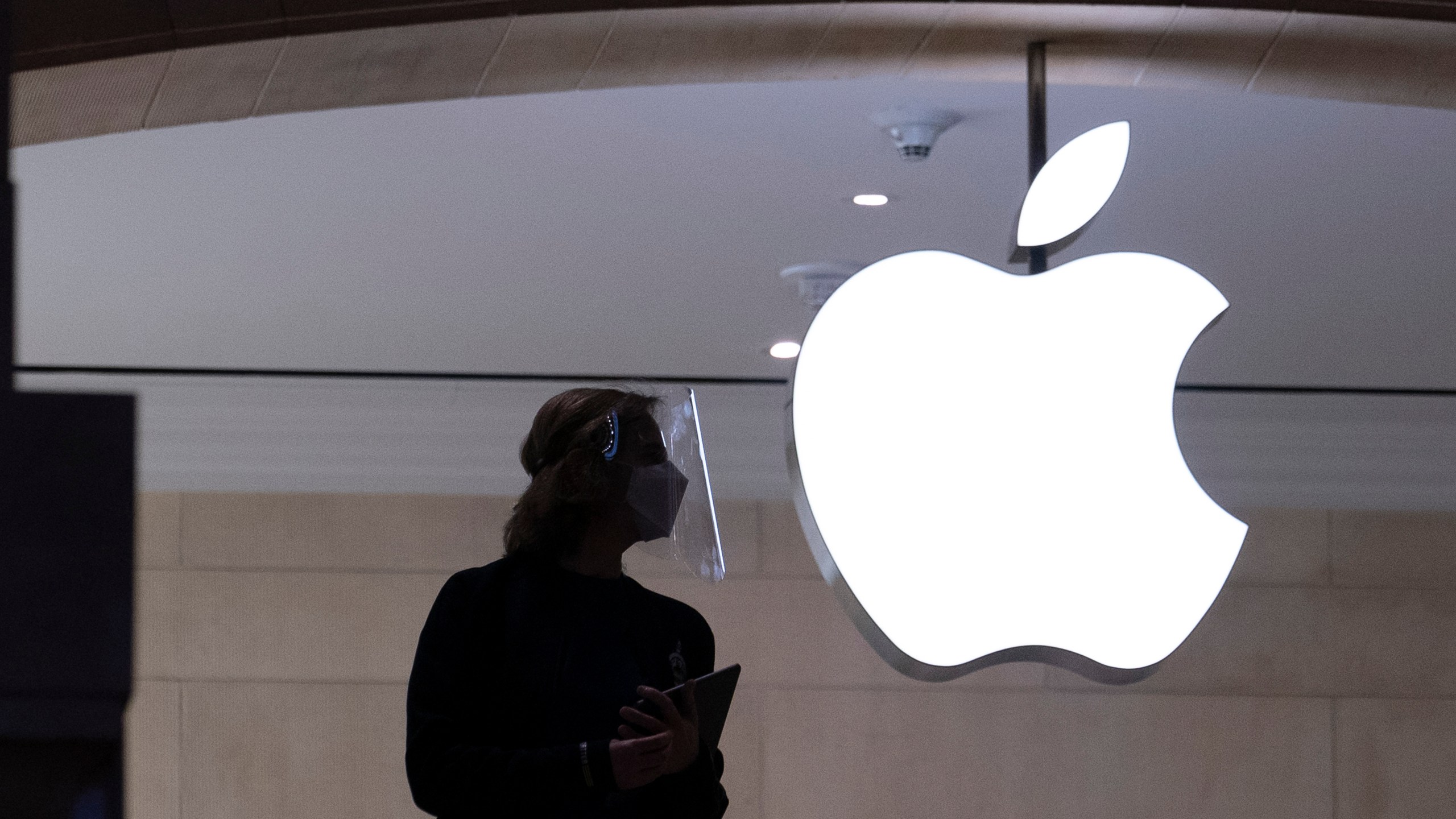 In this Feb. 5, 2021 photo, an Apple store employee is shown in New York. (Mark Lennihan/Associated Press)