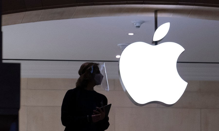 In this Feb. 5, 2021 photo, an Apple store employee is shown in New York. (Mark Lennihan/Associated Press)