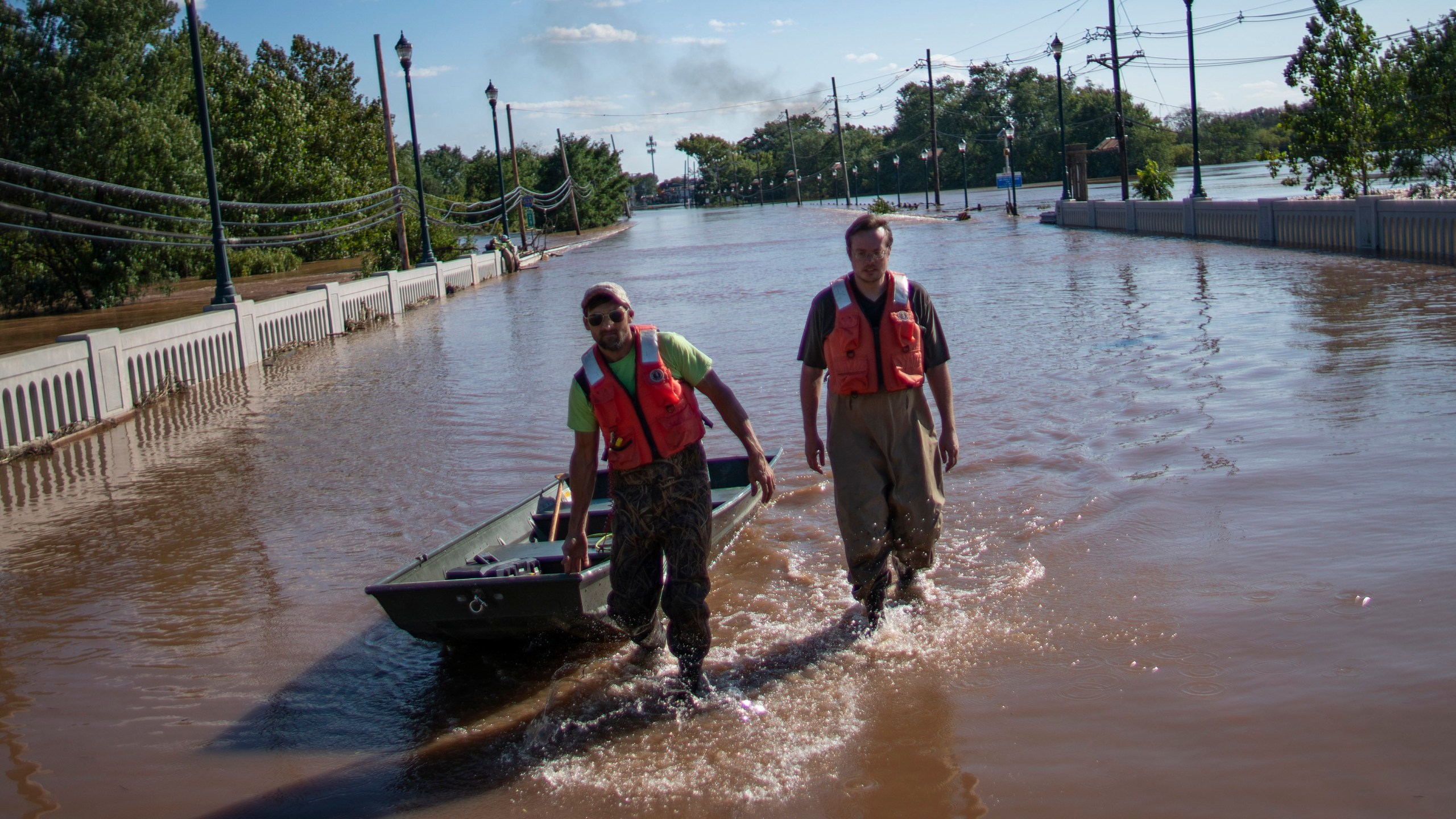 United States Geological Survey workers push a boat as they look for residents on a street flooded as a result of the remnants of Hurricane Ida in Somerville, NJ., Thursday, Sept. 2, 2021. (AP Photo/Eduardo Munoz Alvarez)