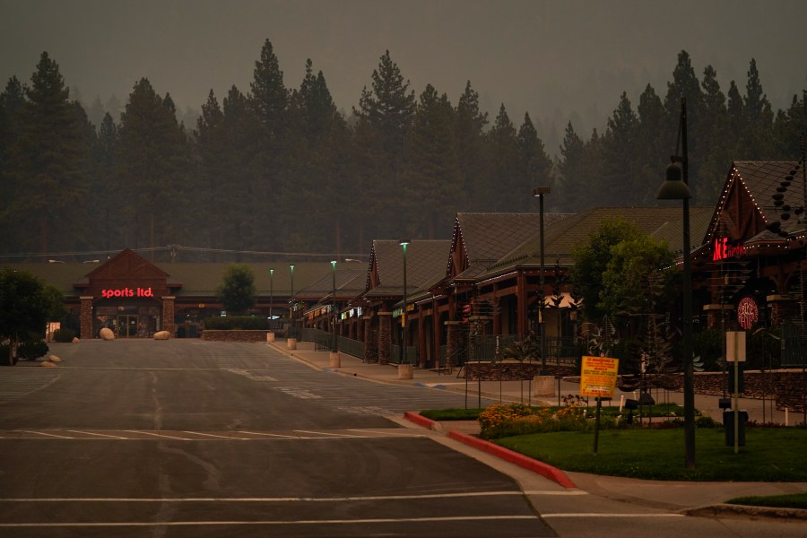 In this Tuesday, Aug. 31, 2021, file photo, a shopping mall is empty after a mandatory evacuation was ordered due to the Caldor Fire in South Lake Tahoe, Calif. State fire officials said evacuation orders for the area were reduced to warnings as of 3 p.m. on Sunday, Sept. 5. Some 22,000 people had been forced to flee the popular resort and nearby areas last week as the Caldor Fire roared toward it. (AP Photo/Jae C. Hong, File)