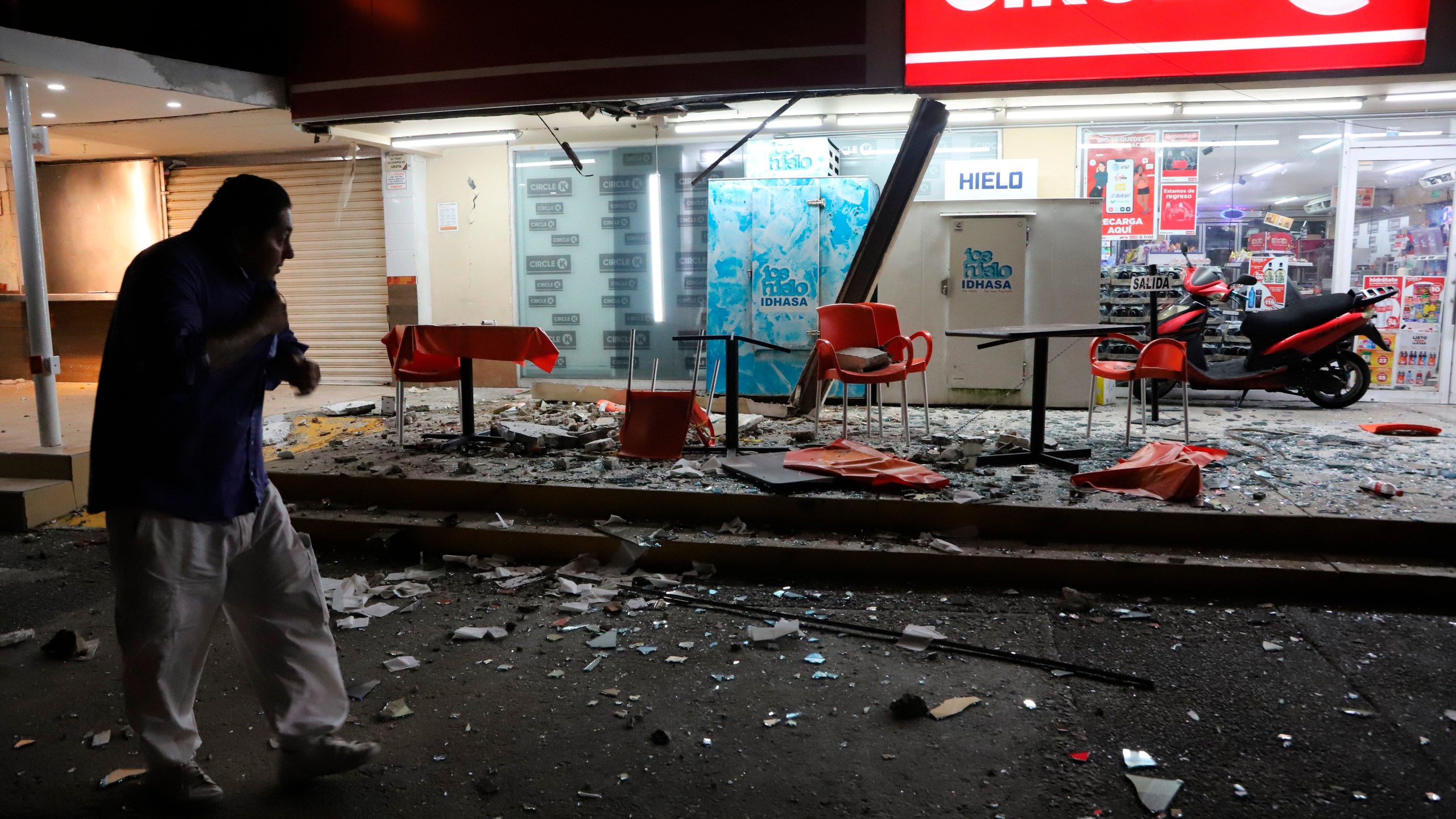 A man walks in from of a convenience store on a street covered with debris after a strong earthquake, in Acapulco, Mexico, Tuesday, Sept. 7, 2021. The quake struck southern Mexico near the resort of Acapulco, causing buildings to rock and sway in Mexico City nearly 200 miles away. (AP Photo/ Bernardino Hernandez)