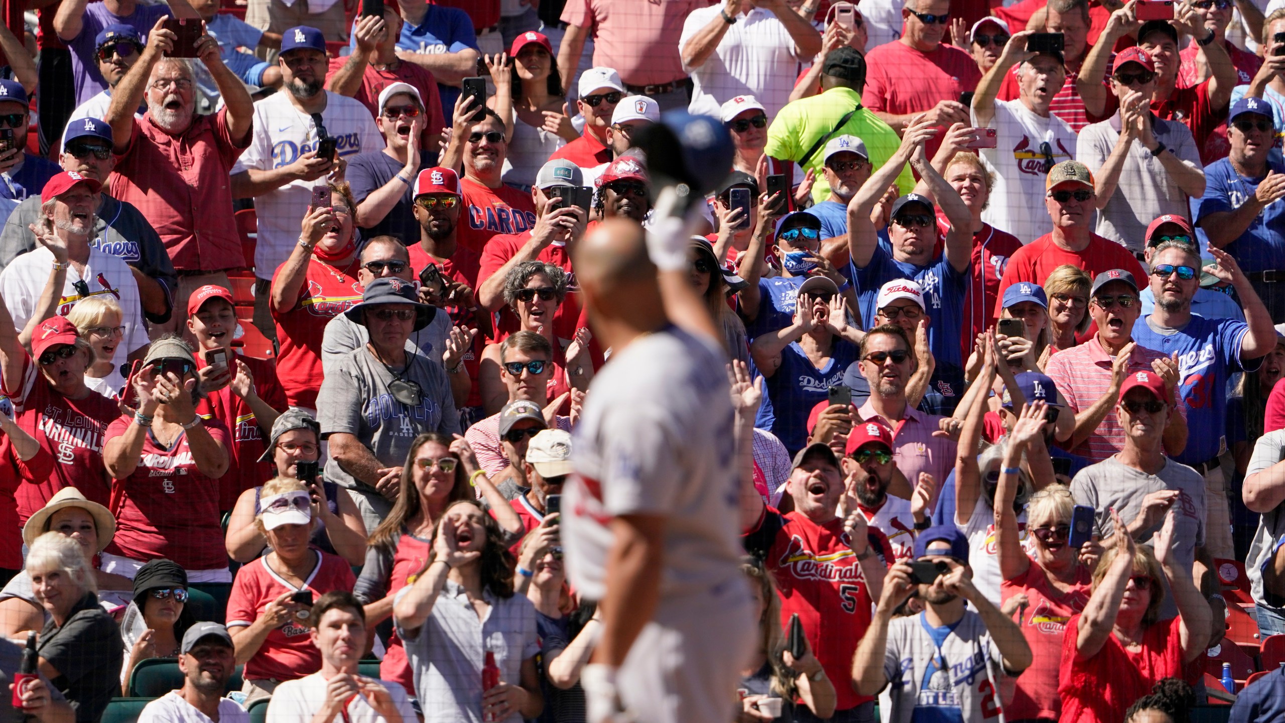 Los Angeles Dodgers' Albert Pujols tips his cap to cheering fans as he steps up to bat during the seventh inning of a baseball game against the St. Louis Cardinals Thursday, Sept. 9, 2021, in St. Louis. (AP Photo/Jeff Roberson)