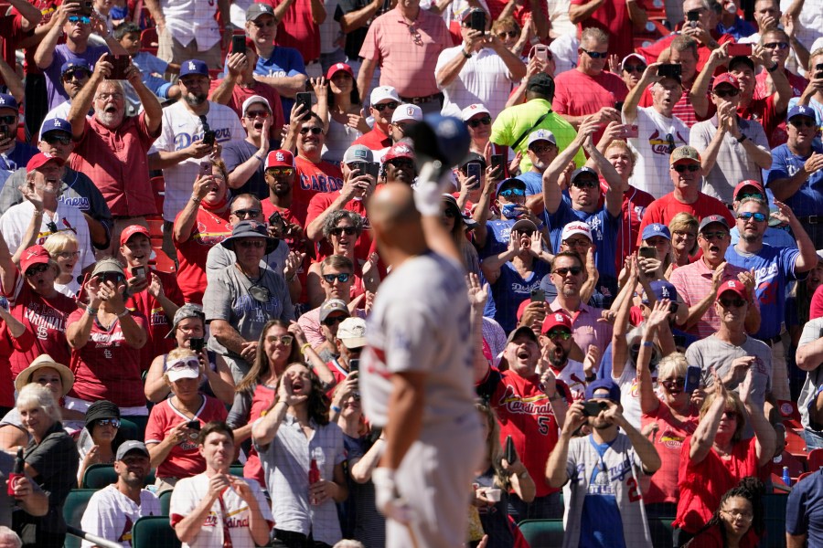 Los Angeles Dodgers' Albert Pujols tips his cap to cheering fans as he steps up to bat during the seventh inning of a baseball game against the St. Louis Cardinals Thursday, Sept. 9, 2021, in St. Louis. (AP Photo/Jeff Roberson)