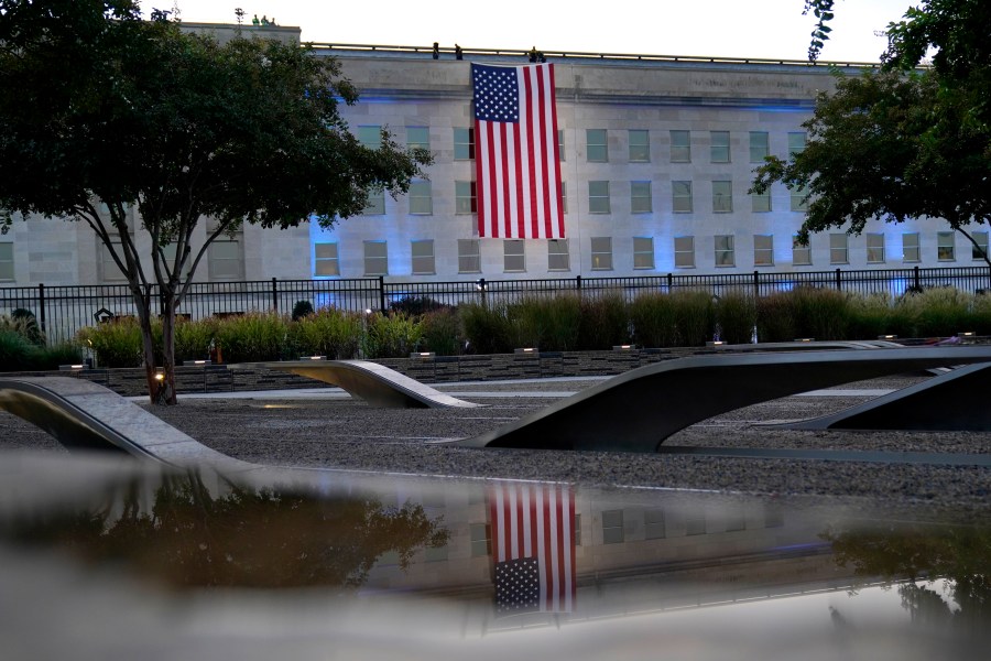 An American flag is unfurled at the Pentagon in Washington, Saturday, Sept. 11, 2021, at sunrise on the morning of the 20th anniversary of the terrorist attacks. (AP Photo/Alex Brandon)