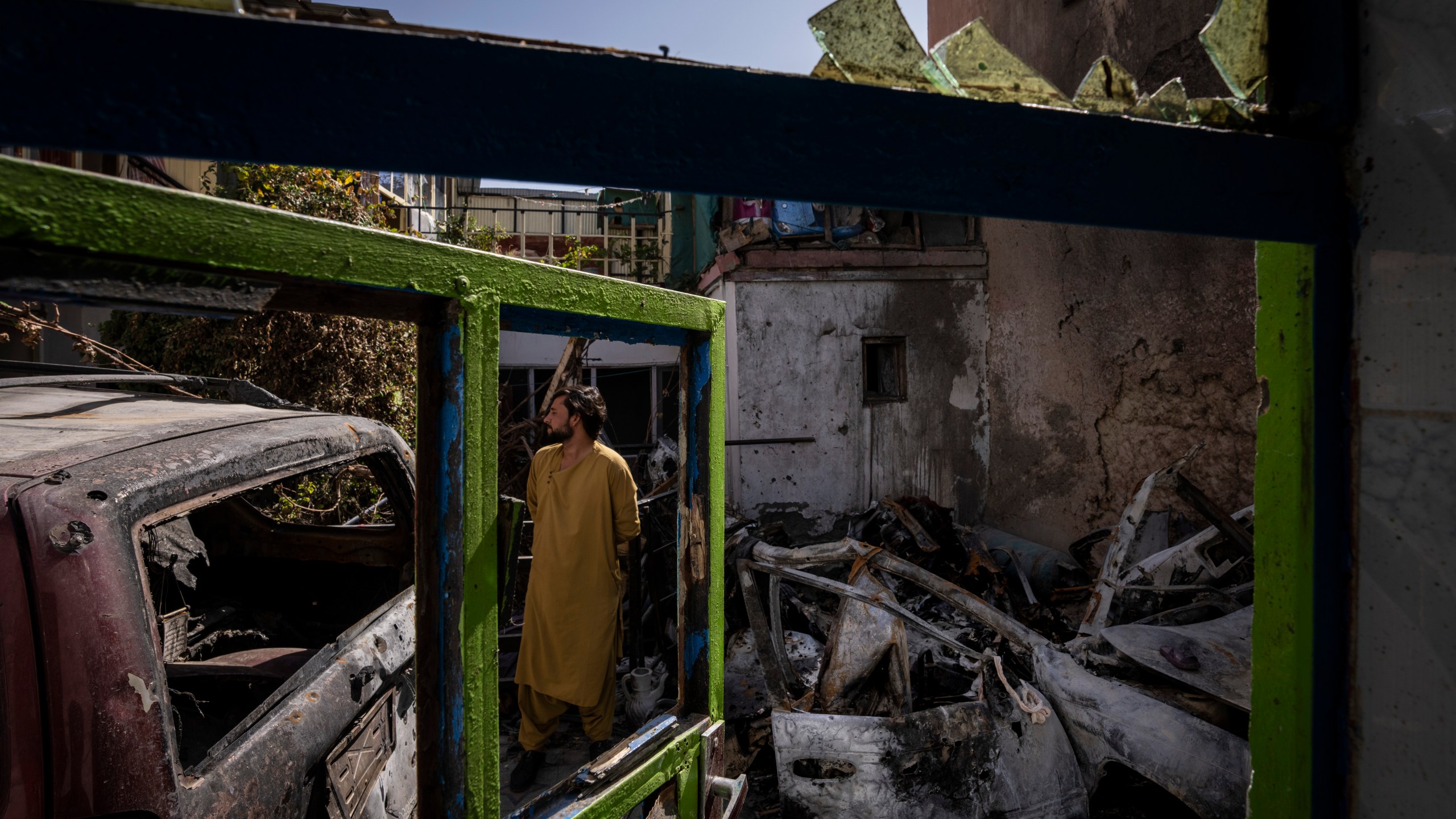 An Afghan inspects the damage of Ahmadi family house in Kabul, Afghanistan, on Sept. 13, 2021. Zemerai Ahmadi, the Afghan man who was killed in a U.S. drone strike last month, was an enthusiastic and beloved longtime employee at an American humanitarian organization, his colleagues say. (Bernat Armangue / Associated Press)