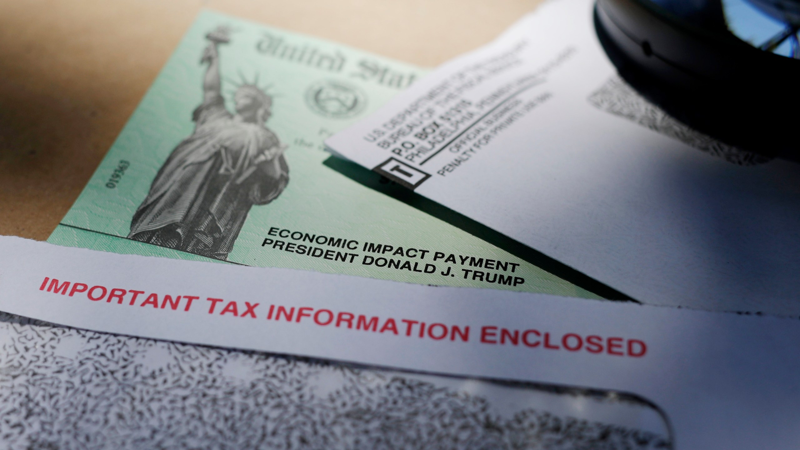 In this April 23, 2020, file photo, President Donald Trump's name is seen on a stimulus check issued by the IRS to help combat the adverse economic effects of the COVID-19 outbreak, in San Antonio. (AP Photo/Eric Gay, File)