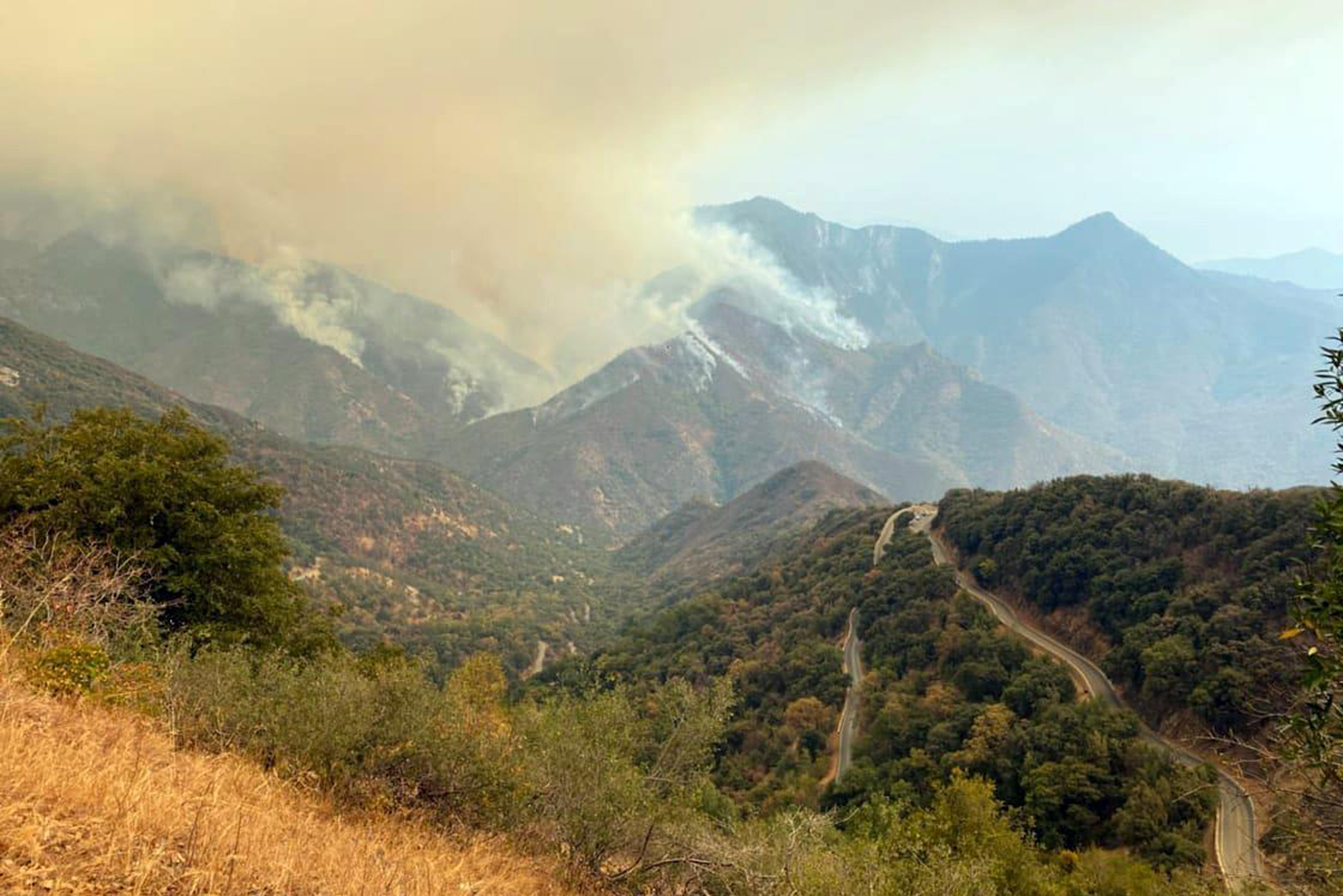 In this Sunday, Sept. 12, 2021 photo released by the KNP Complex Fire Incident Command, smoke plumes rise from the Paradise Fire in Sequoia National Park, Calif. In the southern Sierra Nevada, two fires ignited by lightning are burning in Sequoia National Park. (KNP Complex Fire Incident Command via AP)