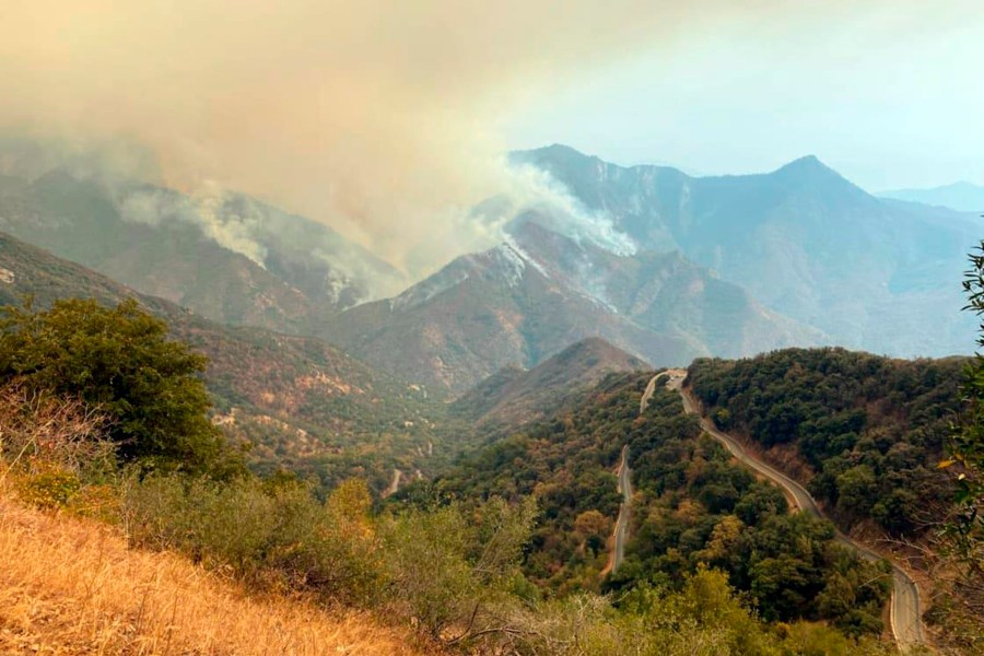 In this Sunday, Sept. 12, 2021 photo released by the KNP Complex Fire Incident Command, smoke plumes rise from the Paradise Fire in Sequoia National Park, Calif. In the southern Sierra Nevada, two fires ignited by lightning are burning in Sequoia National Park. (KNP Complex Fire Incident Command via AP)