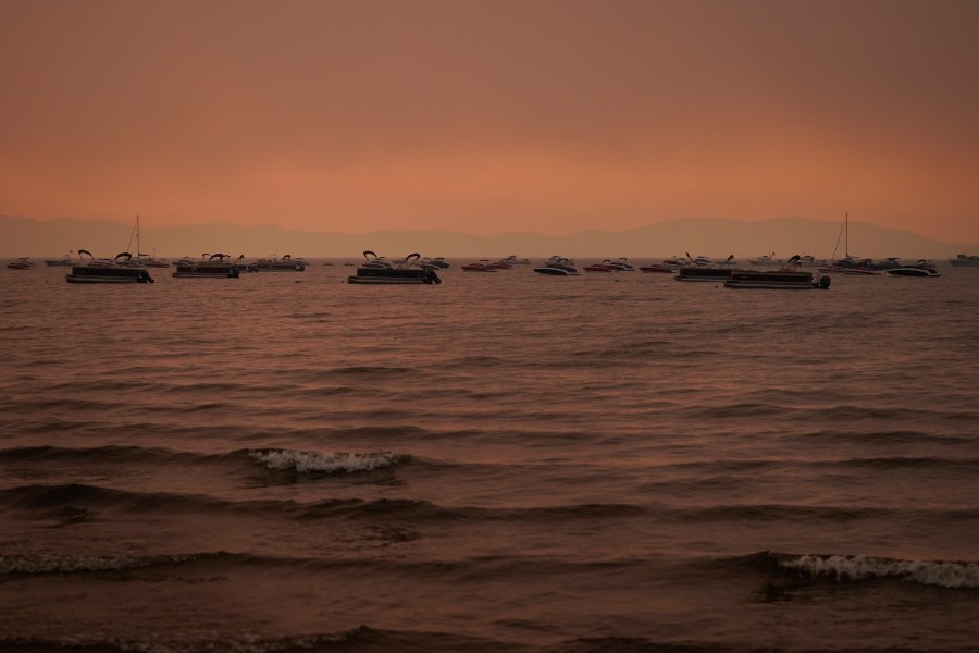 Boats float in the water away from a dock in South Lake Tahoe, Calif., as the Caldor Fire approaches on Aug. 31, 2021. (Jae C. Hong / Associated Press)