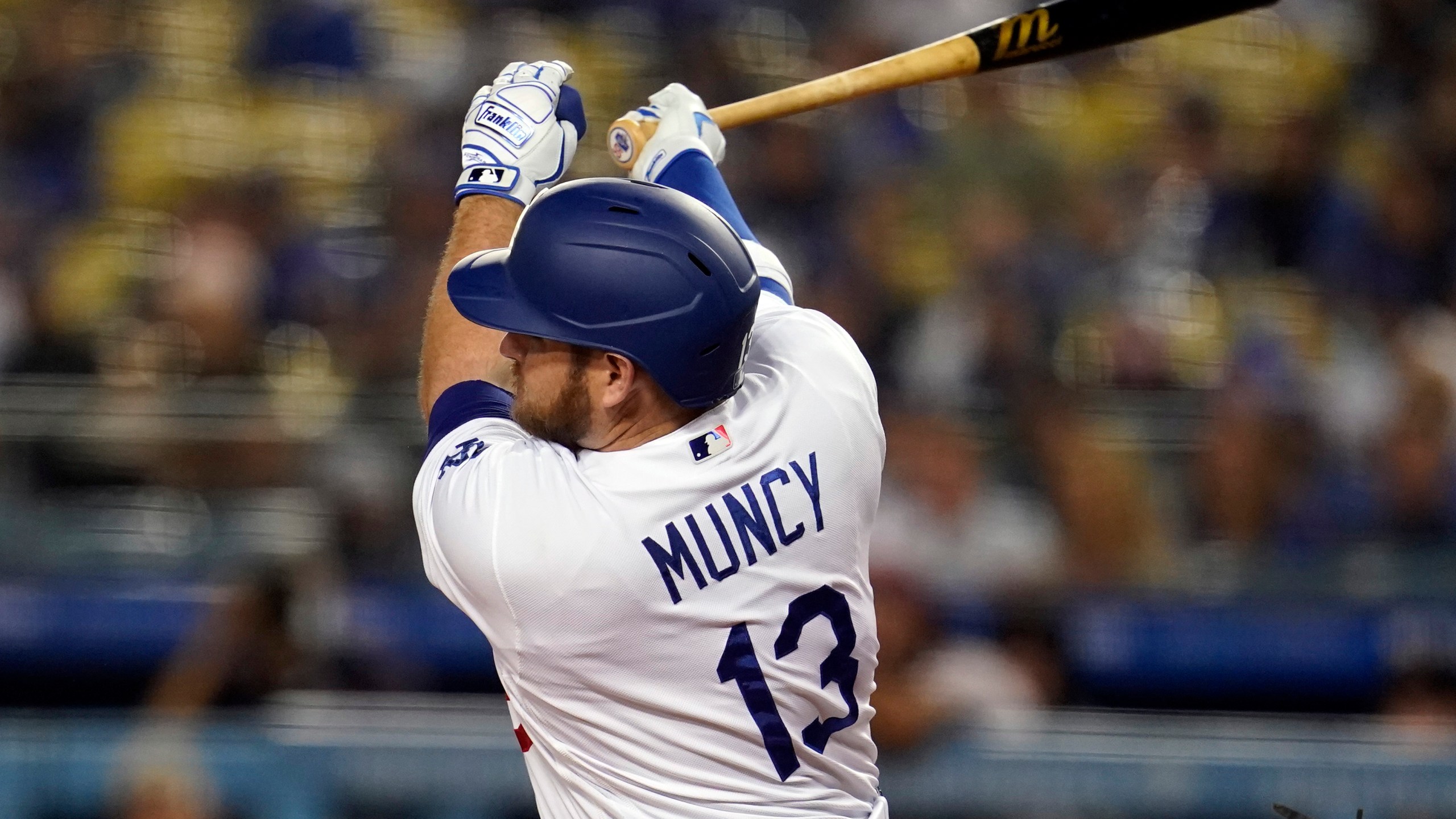 Los Angeles Dodgers' Max Muncy follows through on a double during the first inning of a baseball game against the Arizona Diamondbacks Tuesday, Sept. 14, 2021, in Los Angeles. (AP Photo/Marcio Jose Sanchez)