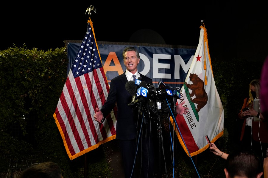 California Gov. Gavin Newsom addresses reporters after beating back the recall attempt that aimed to remove him from office, at the John L. Burton California Democratic Party headquarters in Sacramento, Calif., Tuesday, Sept. 14, 2021. (AP Photo/Rich Pedroncelli)