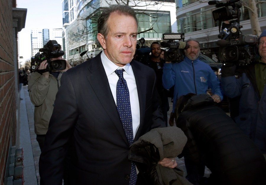 In this March 25, 2019 file photo, Gordon Ernst, former Georgetown tennis coach, departs federal court in Boston after facing charges in a nationwide college admissions bribery scandal. (Steven Senne/Associated Press)