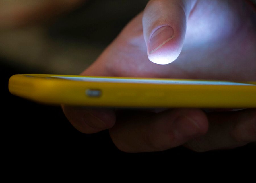 In this Aug. 11, 2019, file photo, a man uses a cellphone in New Orleans. (AP Photo/Jenny Kane, File)