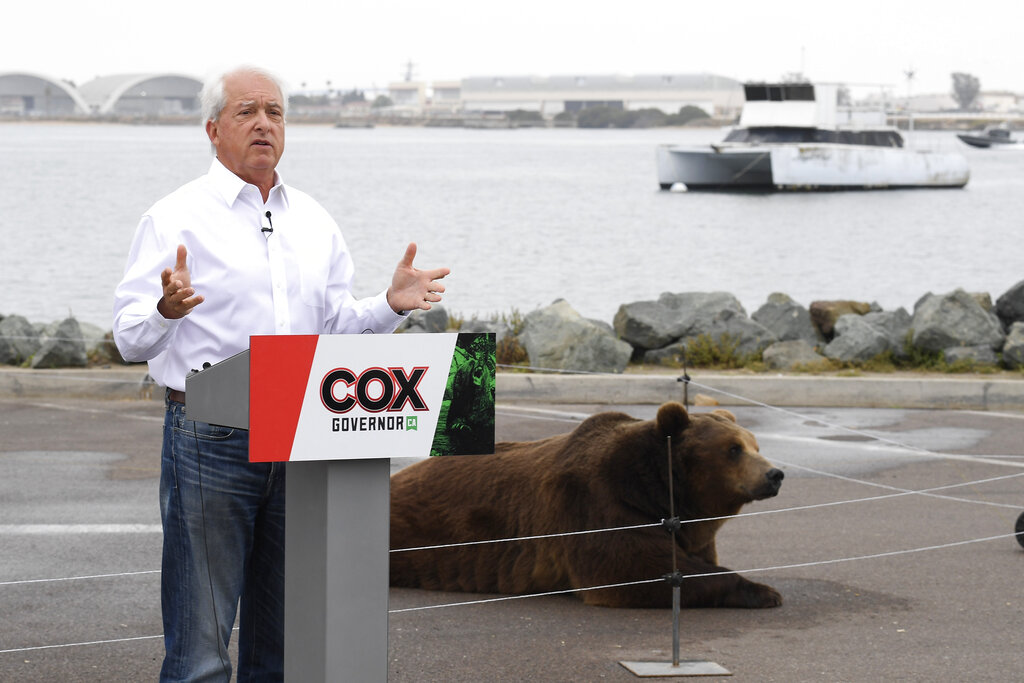 In this May 11, 2021, file photo, California gubernatorial candidate John Cox speaks in front of his Kodiak bear at a campaign event held on Shelter Island in San Diego. (AP Photo/Denis Poroy, File)