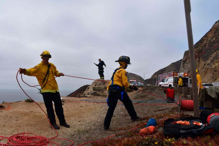 In this photo provided by Cal Fire San Mateo, Santa Cruz Unit firefighters recover a vehicle that plunged off a cliffside road killing a man south of San Francisco on Sept. 15, 2021. (CAL FIRE San Mateo - Santa Cruz Unit via Associated Press)