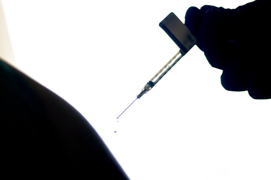 In this Dec. 15, 2020, file photo, a droplet falls from a syringe after a person was injected with the Pfizer COVID-19 vaccine at a hospital in Providence, R.I. (AP Photo/David Goldman, File)