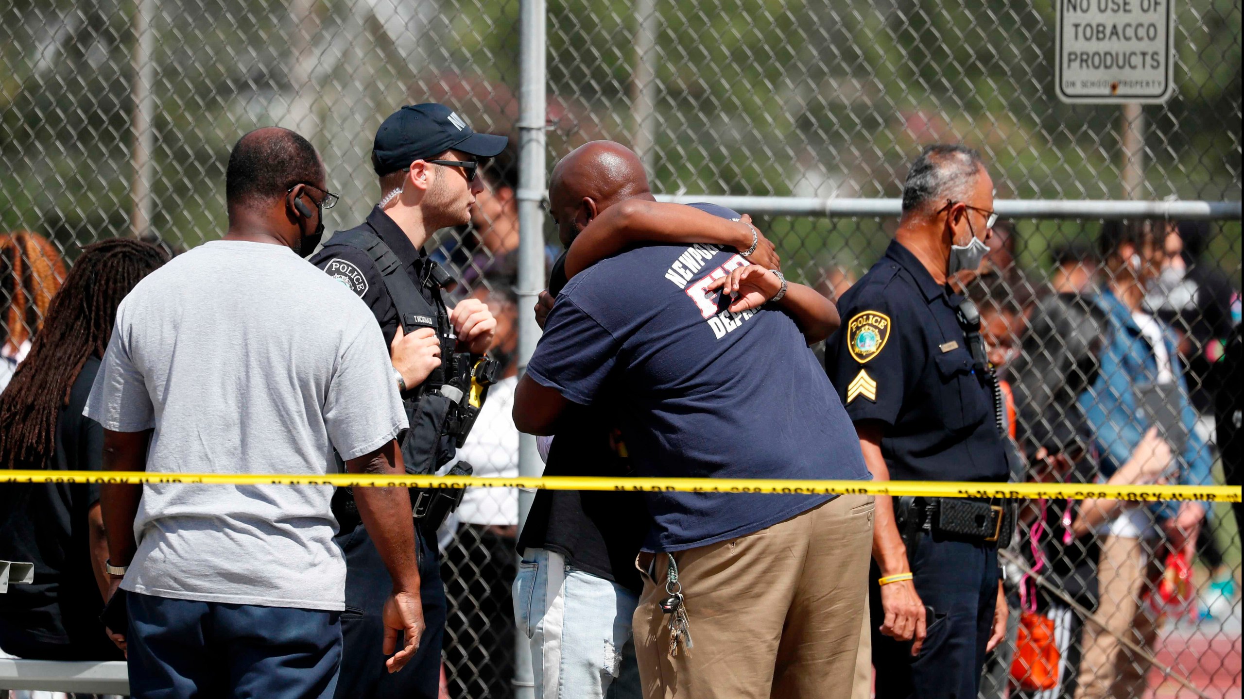 People embrace outside Heritage High School as Newport News Police are on scene responding to a shooting incident Monday, Sept. 20, 2021 in Newport News, Va. (Jonathon Gruenke/The Virginian-Pilot via AP)