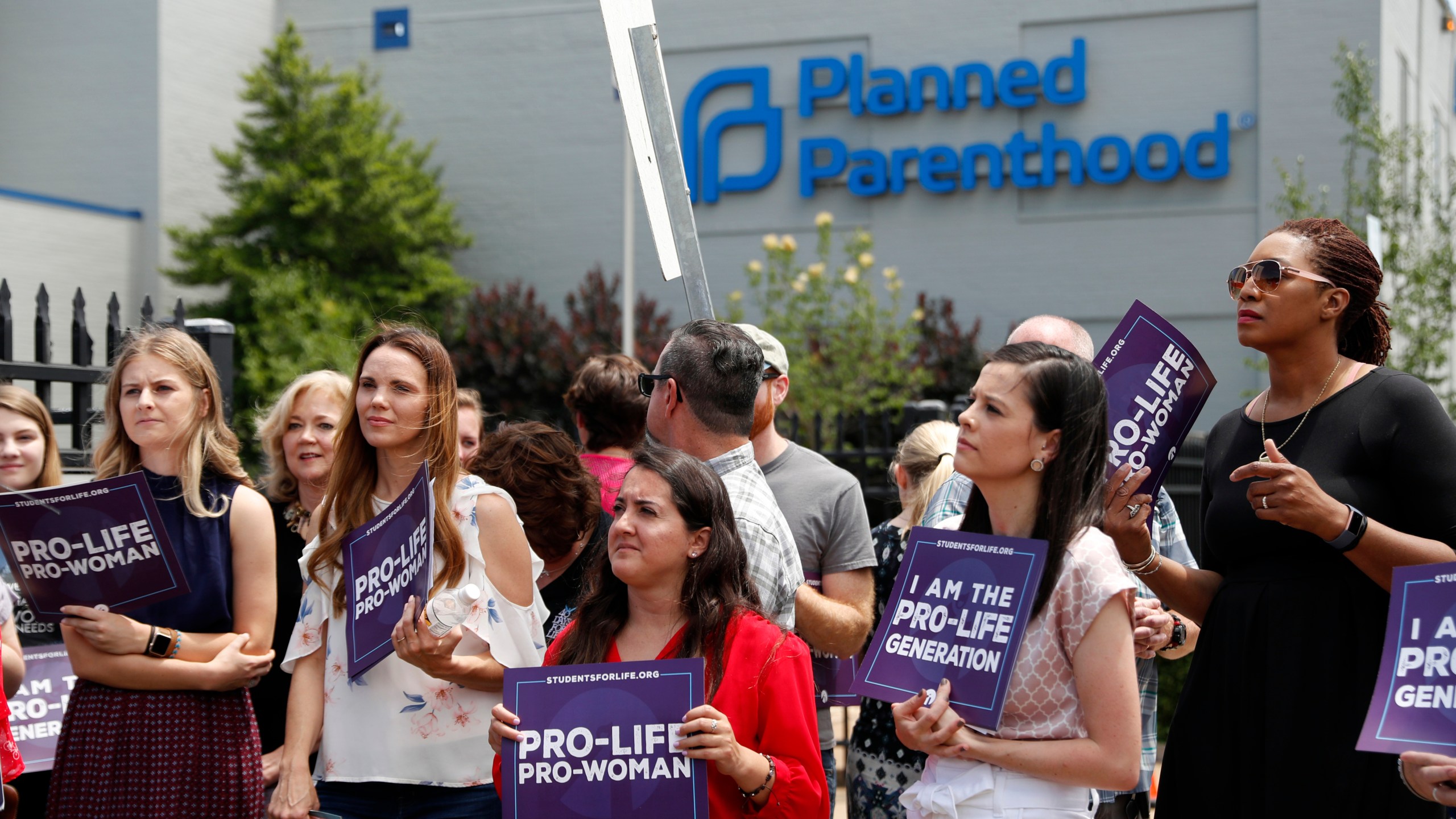 In this June 4, 2019, file photo, anti-abortion advocates gather outside the Planned Parenthood clinic in St. Louis. A federal appeals court on Tuesday, Sept. 21, 2021, will consider whether Missouri can implement a sweeping law aimed at limiting abortions. The law adopted in 2019 would ban abortions at or around the eighth week of pregnancy. It also would prohibit abortions based on a Down syndrome diagnosis. (AP Photo/Jeff Roberson, File)