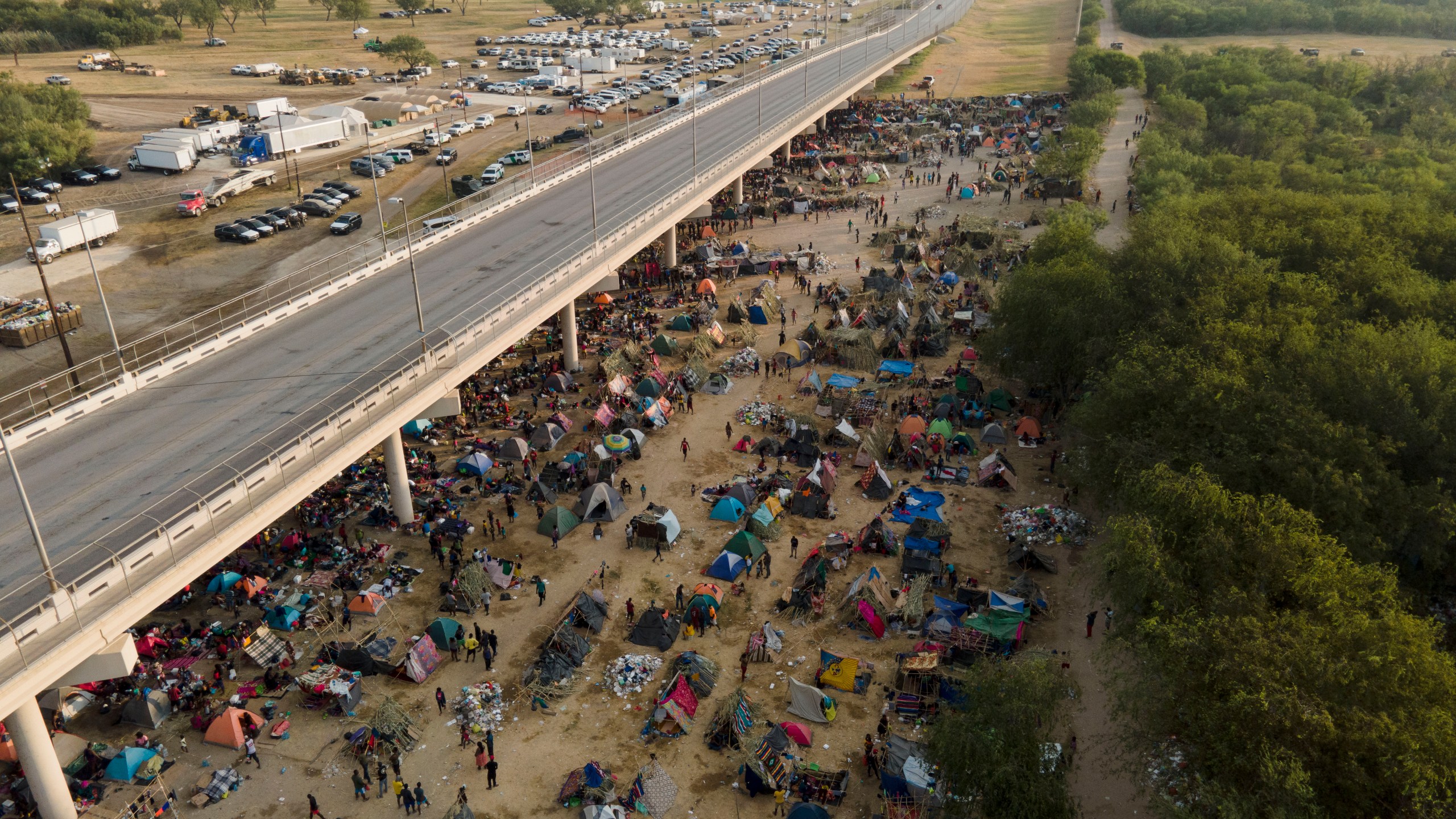 Migrants, many from Haiti, are seen at an encampment along the Del Rio International Bridge near the Rio Grande in Del Rio, Texas, on Sept. 21, 2021. (Julio Cortez / Associated Press)