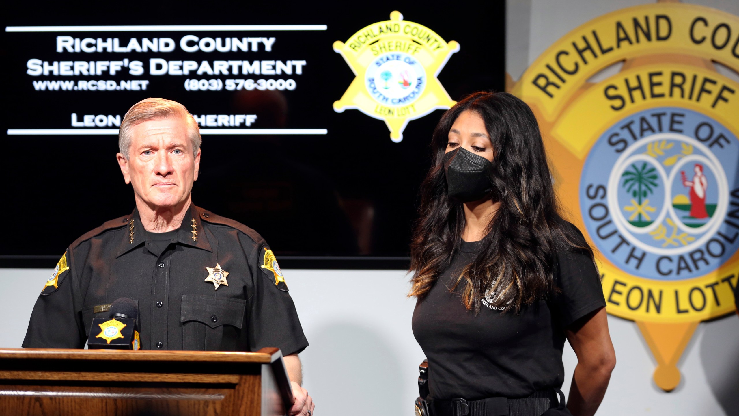 Richland County Sheriff Leon Lott, left, and Coroner Nadia Rutherford, right, talk about the heat deaths of two 20-month-old twin boys during a news conference on Tuesday, Sept. 21, 2021, in Columbia, S.C. Authorities ruled the deaths an accident after the father was distracted by intense pressure at work and no charges will be filed. (AP Photo/Jeffrey Collins)